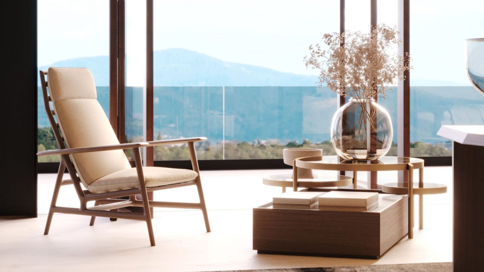 A serene reading corner featuring the Ripa armchair with soft cushions positioned toward expansive mountain views, creating a peaceful setting for daily rituals. A sculptural coffee table with natural textures anchors the space, reflecting the calming influence of modern furniture, refined luxury home furniture, and the grounding warmth of wood design within wellness‑focused interiors.