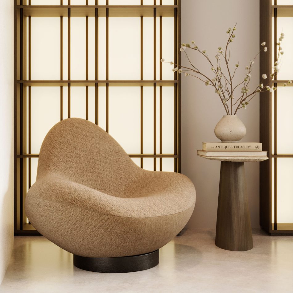 The Stone Armchair sits beside the Stone Side Table in a warm, softly lit interior, its rounded beige upholstery and wood circular base echoing natural stone forms while the wooden slatted bookcase, delicate branches, and curated books create a serene ambiance shaped by refined luxury home furniture, thoughtful living room architecture, and nature‑inspired interior design inspiration.