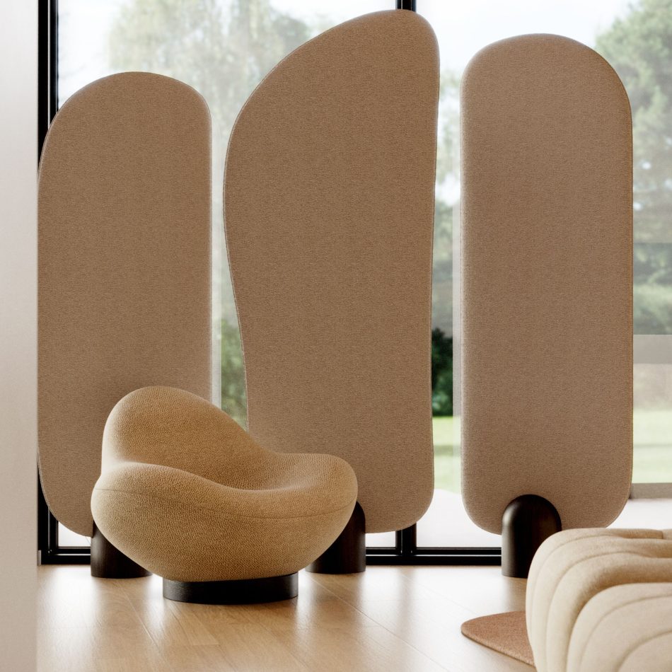 The Stone Armchair is placed in a bright, minimalist room with tall organic room screen and floor‑to‑ceiling windows, its pebble‑like silhouette and textured fabric blending with the soft natural light and outdoor greenery, reflecting the calm sophistication of modern furniture, organic living room inspiration, and contemporary bespoke furniture.