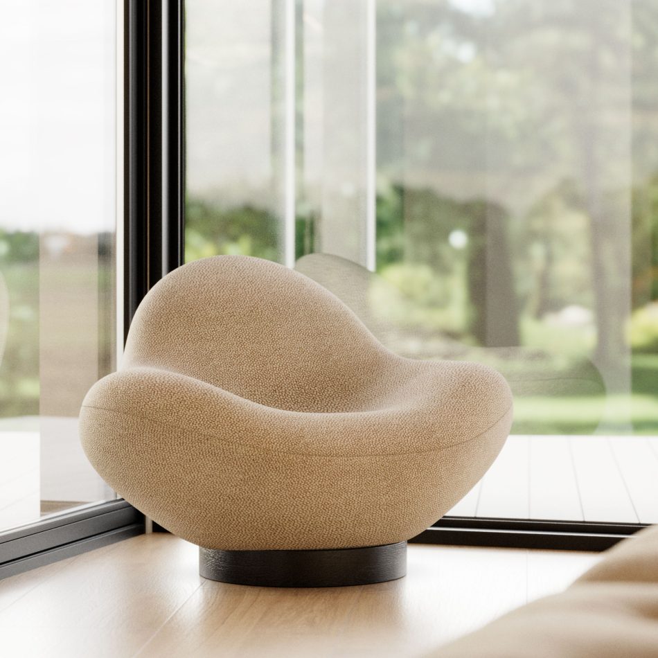 The Stone Armchair sits in a bright, nature‑filled interior with floor‑to‑ceiling glass panels, its pebble‑inspired curves and textured beige fabric illuminated by soft outdoor greenery, forming a serene atmosphere that blends contemporary furniture, tranquil living room architecture, and the understated presence of high end luxury furniture.