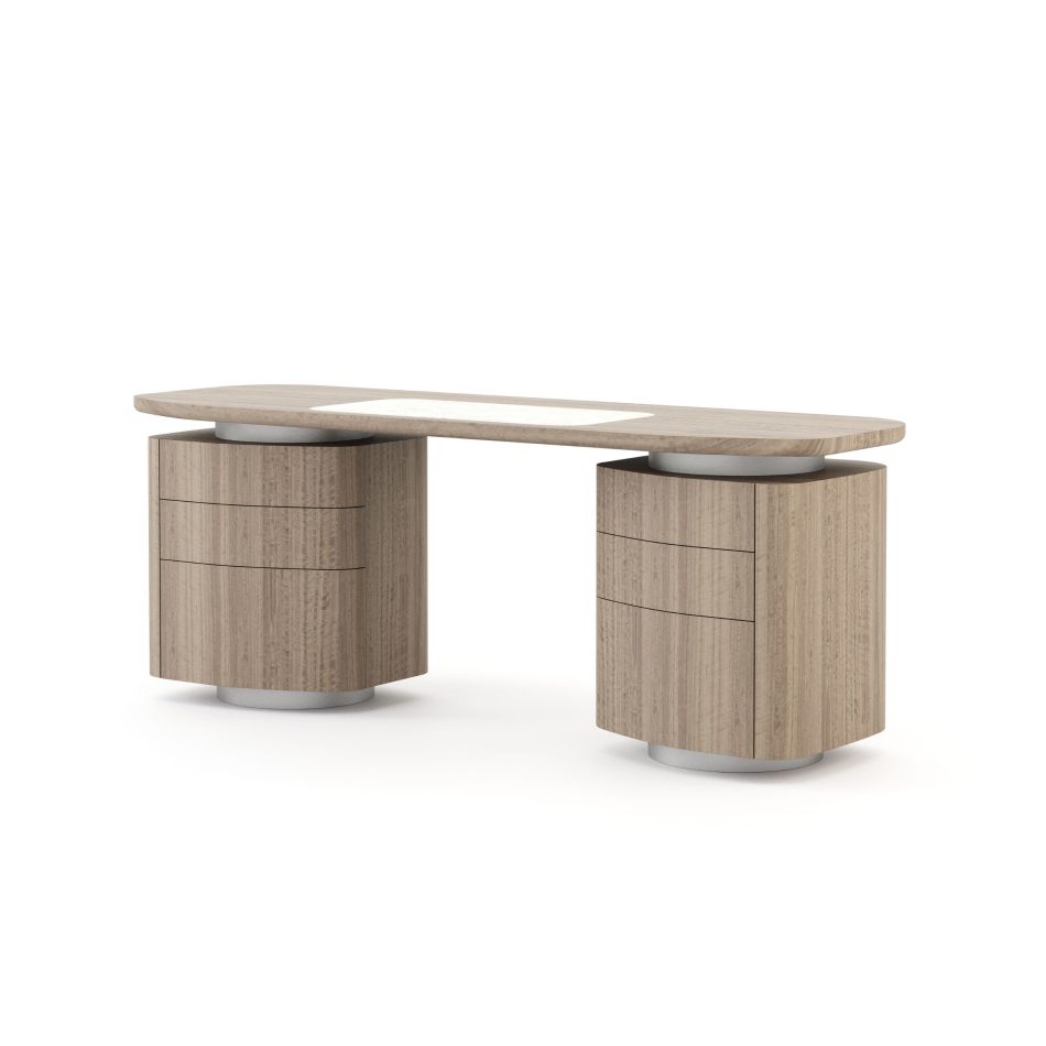 The Stone Desk is presented with a curved wooden top featuring a soft central inlay, supported by two cylindrical pedestal bases with integrated drawers and subtle metallic accents, its warm natural finish and sculptural form creating a modern workspace shaped by curated contemporary furniture, gentle layers of interior design inspiration, refined elements of luxury home furniture, and the clean simplicity associated with thoughtful workspace styling.”