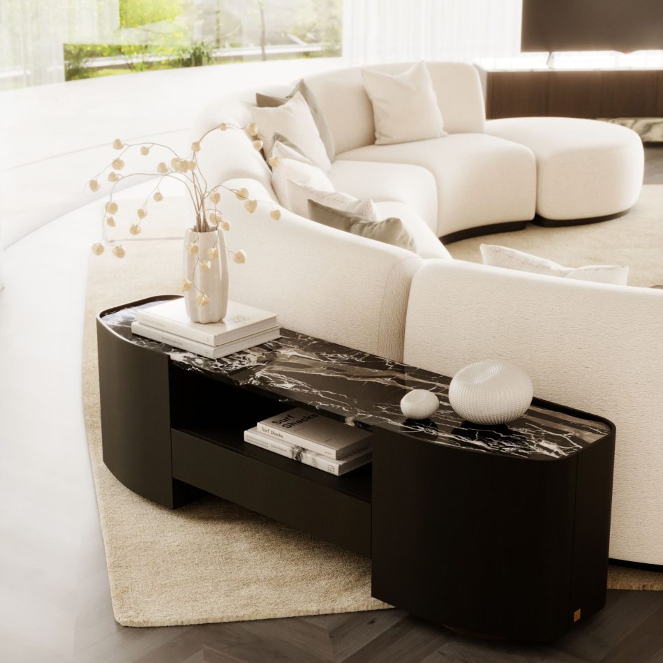 The Stone Sofa curves gracefully through the center of a bright, minimalist living room, its cream modular silhouette layered with soft neutral pillows and positioned before a sleek console with a dark marble top and sculptural decor, all set within an airy space shaped by thoughtful living room furniture choices, subtle touches of modern furniture, curated elements of interior design inspiration, and the warm elegance associated with luxury home furniture.