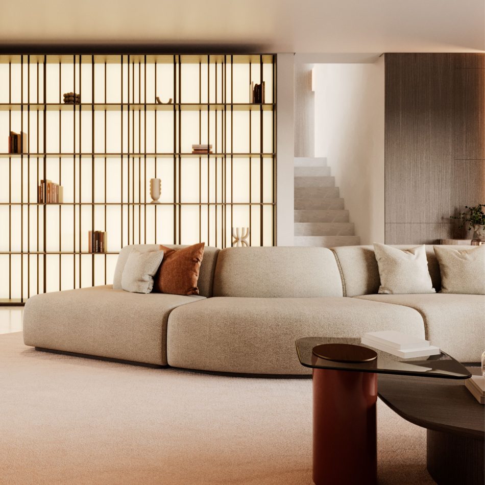 The Stone Sofa is presented in a curved beige configuration with soft neutral pillows, placed before a backlit geometric shelving unit and paired with a dark glass coffee table, forming a harmonious modern setting influenced by curated contemporary furniture, gentle layers of living room architecture, refined elements of luxury home furniture, and the warm simplicity associated with thoughtful design details.