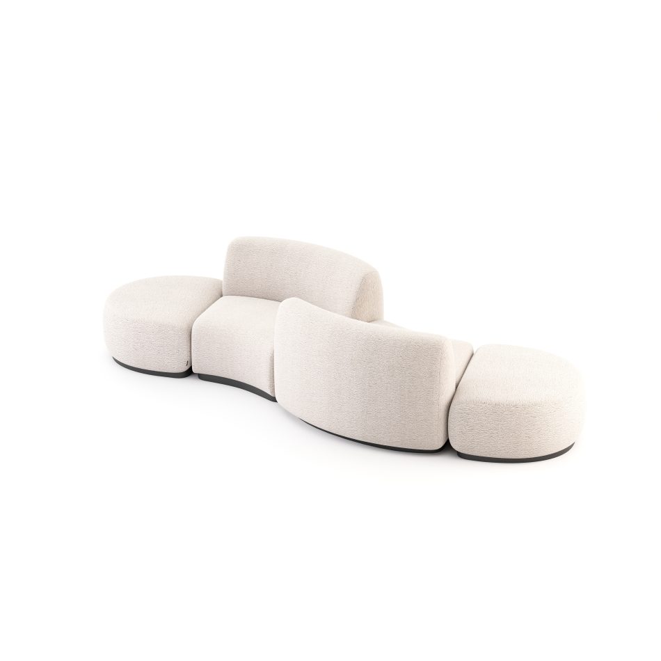 The Stone Sofa appears as a flowing modular composition with rounded end pieces and curved backrests that create a continuous, organic silhouette. The soft upholstery and wood base emphasize the contrast between lightness and stability, mirroring the gentle movement of stones shaped by water and expressing the refined craftsmanship of high end furniture within a serene interior.
