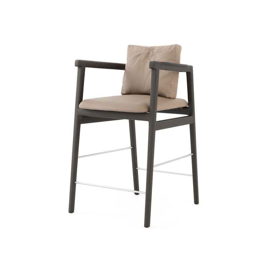 The Toro Bar Stool reveals slender lines and soft curves shaped in dark wood and upholstered in warm fabric, expressing a quiet balance between strength and delicacy that aligns with modern bar chairs, the sculptural refinement of bar furniture, and the crafted elegance of luxury home furniture.