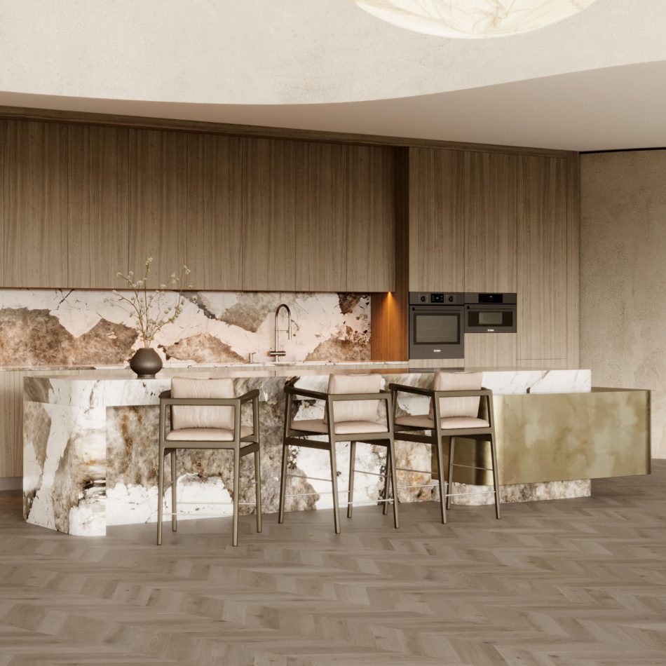 The Toro Bar Stool appears along a marble island in a refined kitchen ambiance, where warm wood cabinetry, soft illumination, and organic accents highlight the stool’s flowing curves and slender geometry, aligned with luxury kitchen furniture, the crafted clarity of modern bar chairs, and the quiet sophistication of high end furniture.