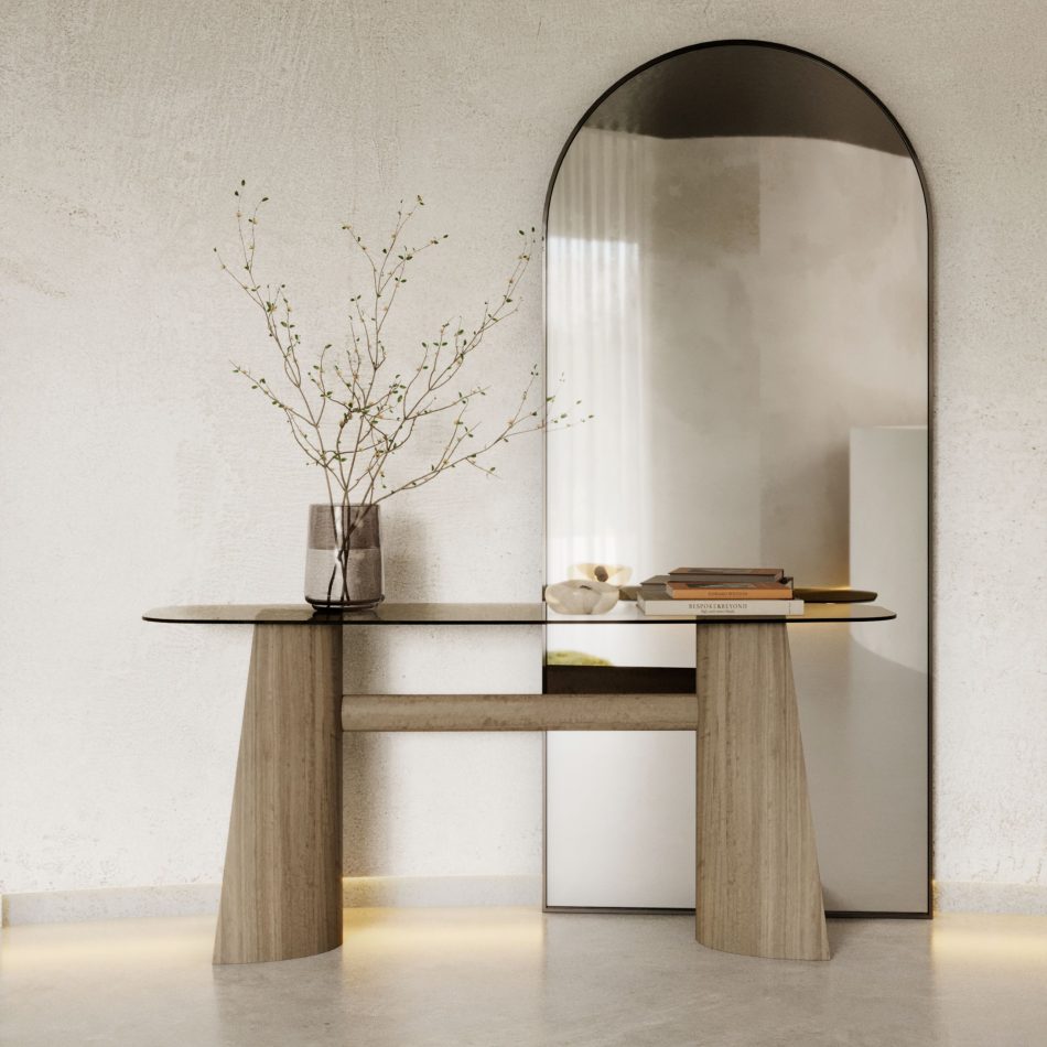 The Toro Console in wood and glass sits within a softly lit interior where an arched mirror, sculptural décor, and warm illumination highlight its balanced proportions and quiet precision, resonating with luxury console table, the refined restraint of modern furniture, and the composed elegance of living room furniture.