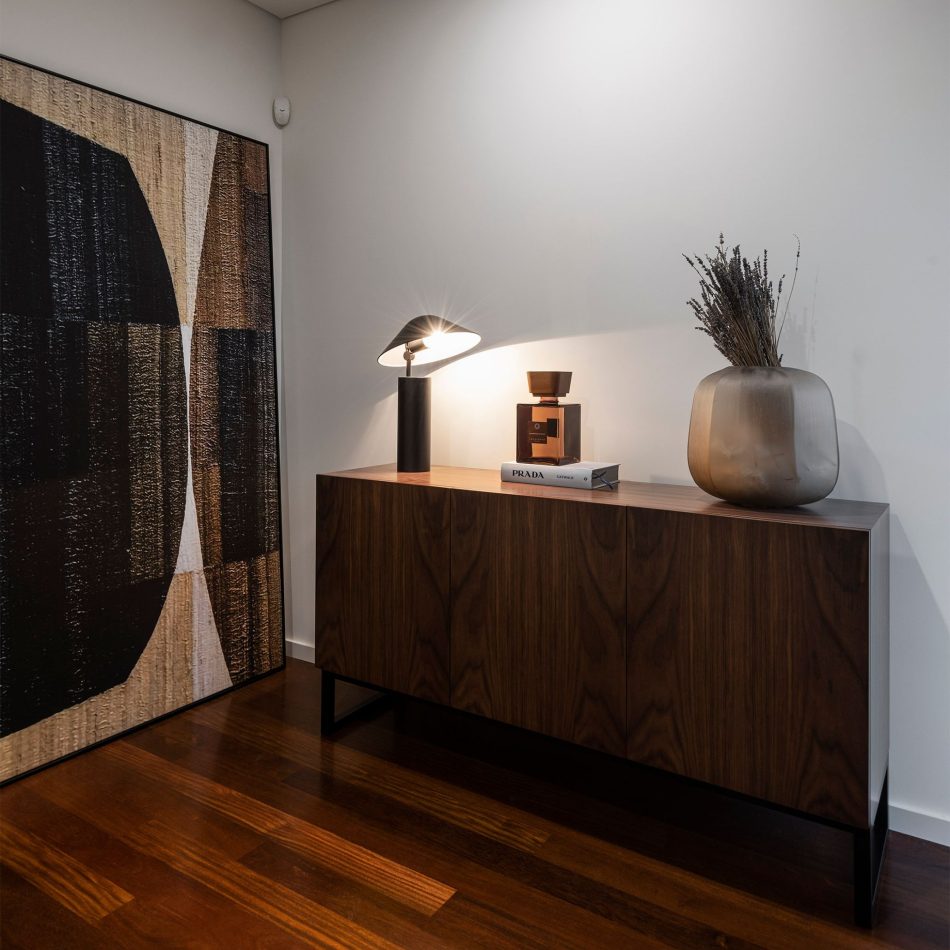 A calm and elegant entrance hall where the Slender Sideboard introduces balance through its minimal silhouette, paired with sculptural décor and warm wood flooring. The space feels intentionally composed, blending luxury home furniture with subtle bespoke furniture details and the quiet refinement of modern furniture that guides the transition from exterior to interior.