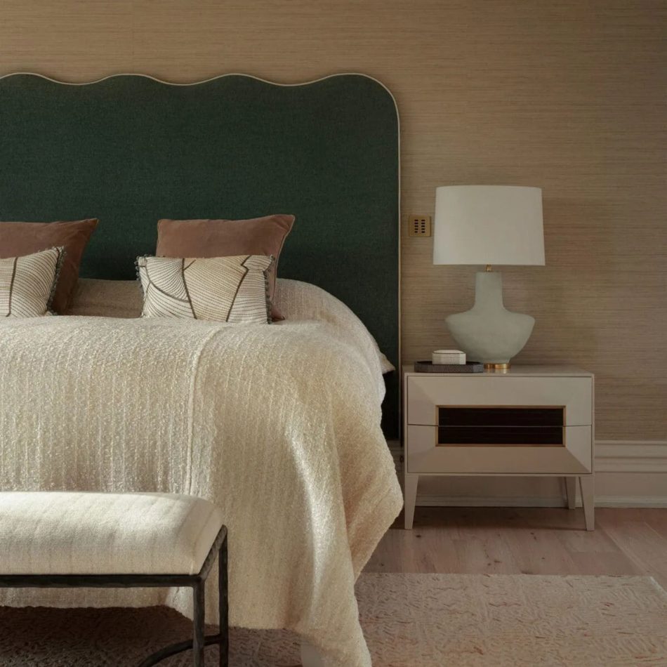 A sophisticated master‑suite composition with a sculptural green headboard, layered pillows, and a textured cream blanket, paired with the Heritage Night Table and a sculptural lamp. The warm tones and crafted details reflect high end bedroom furniture, elegant bedroom furniture, refined design details, and the calm harmony of luxury master bedroom furniture in a contemporary space.