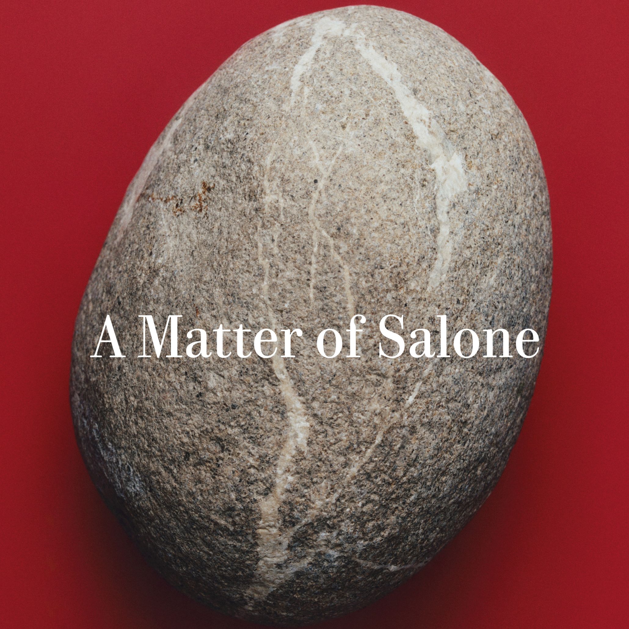 A smooth, veined stone set against a deep red background introduces the theme A Matter of Salone, highlighting the importance of material origin during Milan Design Week. Its raw texture and quiet presence echo the foundations of luxury furniture, inviting a slower, more intentional reading of matter itself. The composition reflects a renewed focus on interior design inspiration, where every surface, density, and detail becomes part of a more thoughtful approach to modern furniture.