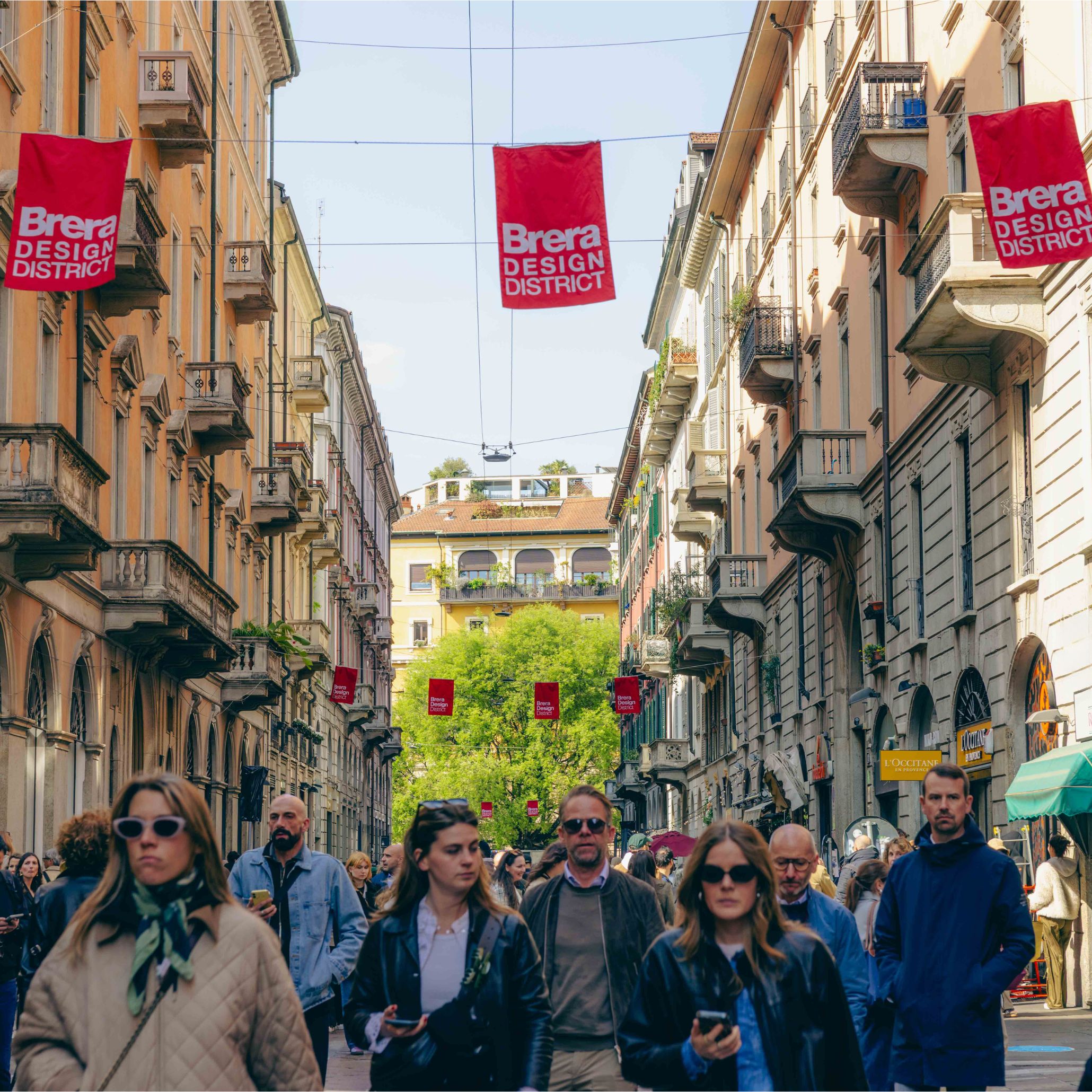 Crowds fill the historic streets of the Brera Design District, moving beneath red banners that signal one of Milan Design Week’s most iconic neighbourhoods. The blend of heritage façades and contemporary installations reflects Brera’s cultural depth, where galleries and studios shape conversations around interior design inspiration, offering a refined lens on modern furniture and influencing the evolving language of luxury furniture across the city.