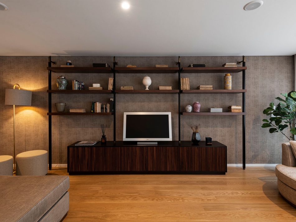 A warm living room where the Sublime Stools introduce soft, rounded comfort that enriches the composition, while the His TV Cabinet and Bespoke Ryan TV Cabinet anchor the space with clean geometry and warm wood finishes. Gentle lighting and natural textures shape an atmosphere of luxury furniture harmony and modern refinement, expressing the understated elegance that defines the home.