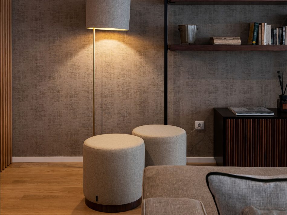 A cozy living room moment where the Sublime Stools introduce soft texture and warm tones beneath the glow of a floor lamp. Their rounded shape and wooden base add subtle character to the minimalist space, enhancing the room’s contemporary furniture expression.