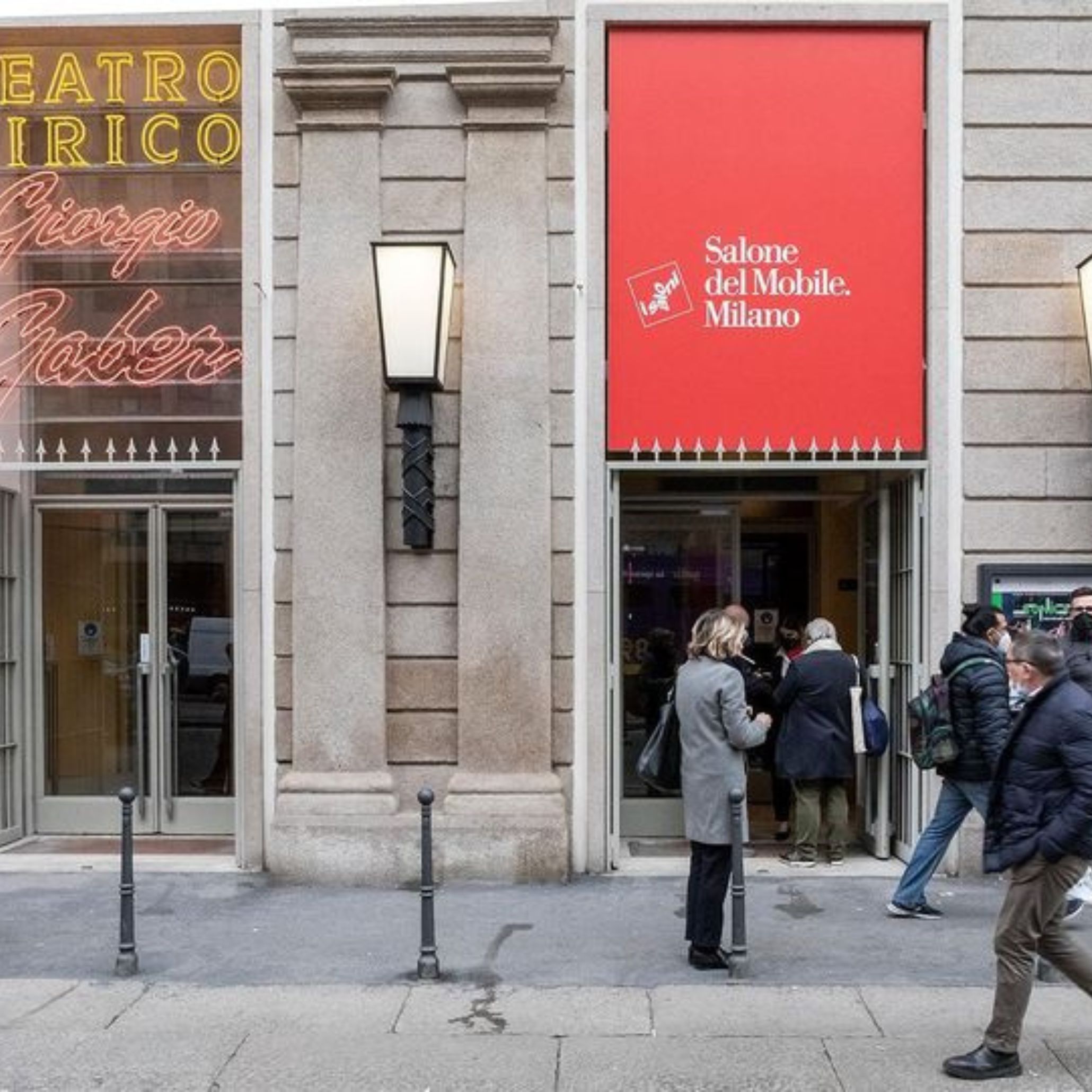 People walk through a central Milan location where Salone del Mobile signage highlights the citywide presence of the event. The scene reflects how Milan becomes an active backdrop during Design Week, guiding visitors through design events, connecting them with interior design trends, and introducing the atmosphere that shapes contemporary furniture, luxury home furniture, and contemporary furniture each year.