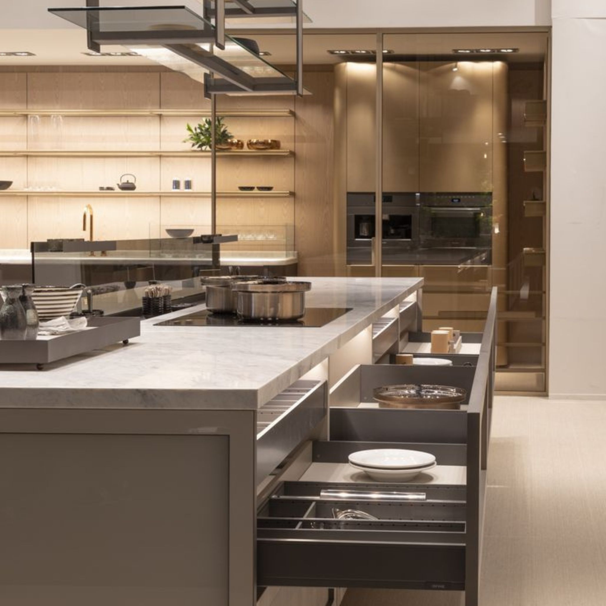 A high‑end kitchen installation presents a marble island, organised storage systems, and built‑in appliances, illustrating the focus on functionality and refinement at EuroCucina. The display emphasises how innovation shapes the kitchen as a central living space, bringing together modern interiors, thoughtful spatial planning, and elevated luxury design connected to luxury kitchen furniture and modern kitchen furniture.