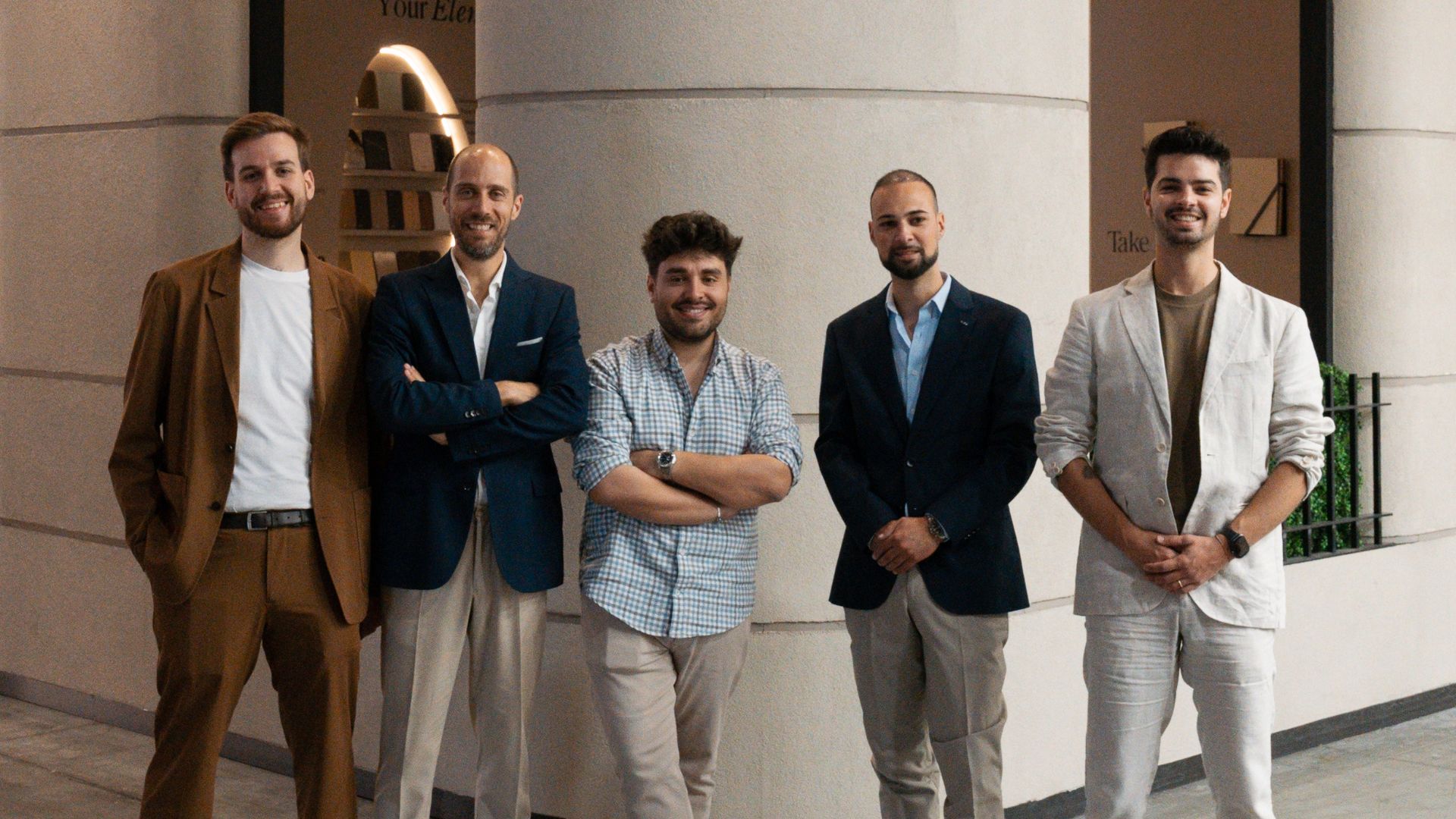 The Stylish Club team stands together outside the stand, framed by soft architectural curves that echo the brand’s elemental concept. Their relaxed posture and coordinated attire reflect the collaborative spirit that shaped this edition of the fair, where conversations and shared creativity defined the week. This moment captures the human presence behind high end furniture, the craftsmanship associated with luxurious furniture, and the sense of connection that continues to inspire hospitality designs.