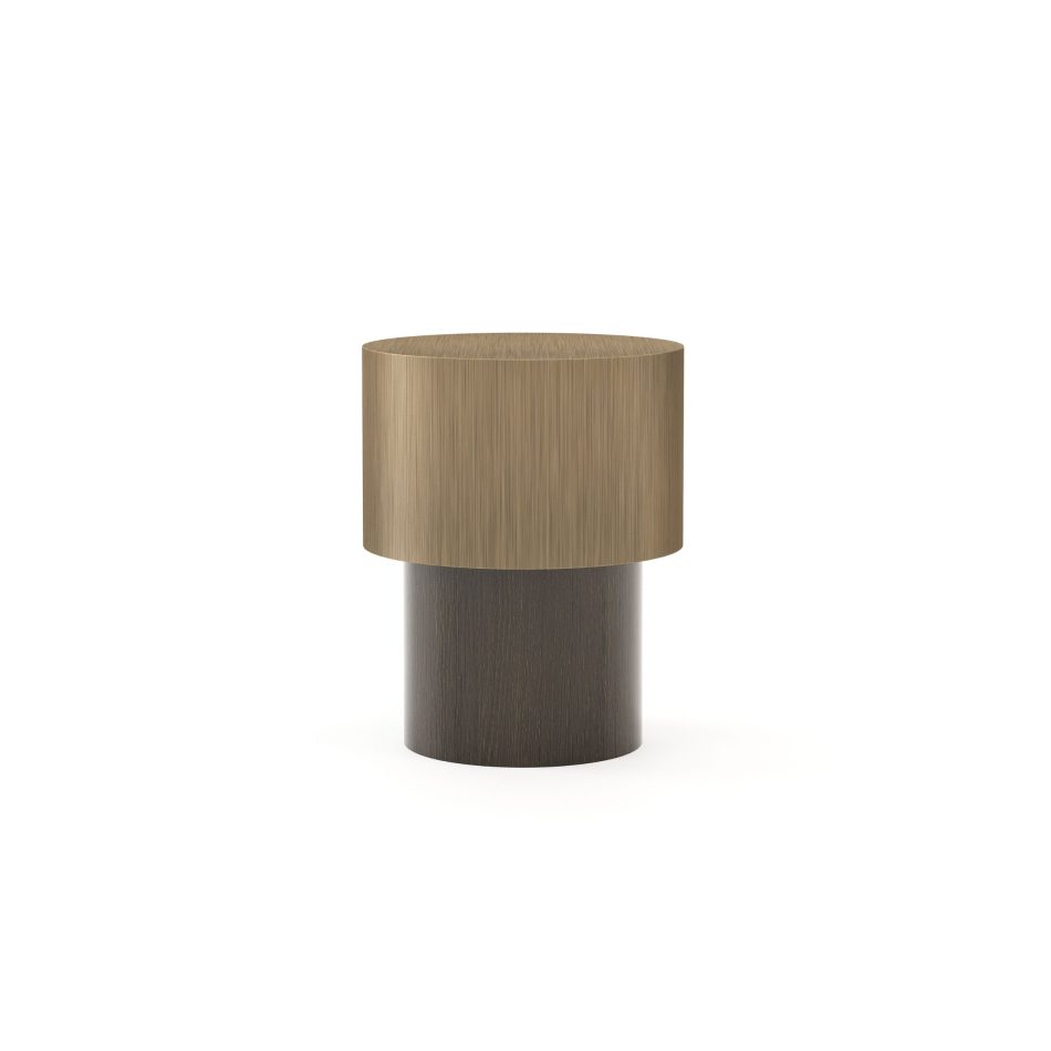 The Toro Side Table III features a brushed brass cylindrical top rising above a deep wood base, creating contrast that highlights its architectural presence. This refined composition enhances curated interiors with luxury living room furniture, elevates modern spaces through design details, and complements expressive contemporary furniture aesthetics.