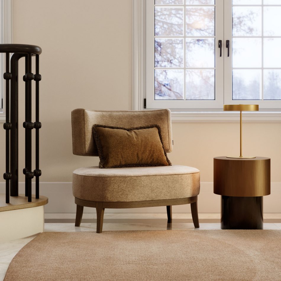 A serene reading corner features a soft beige armchair with a warm brown cushion, paired with a small gold side table topped by a matching lamp. Sunlight filters through the large window framed by autumn foliage, creating a calm, inviting atmosphere that enriches home decor, elevates the mood of interior design, and adds a refined touch to living spaces.
