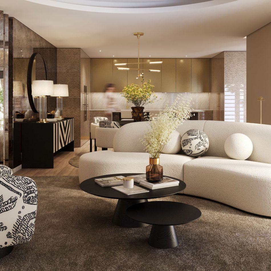 The open space reveals the Cotton cream sofa facing two Sahara Coffee Tables, styled with books and an amber vase. A patterned armchair and the bold Her Sideboard add rhythm, while the dining area and kitchen unfold seamlessly in the background. This balanced setting highlights thoughtful living room furniture, elevated by sculptural contemporary furniture, and arranged to spark warm living room inspiration.