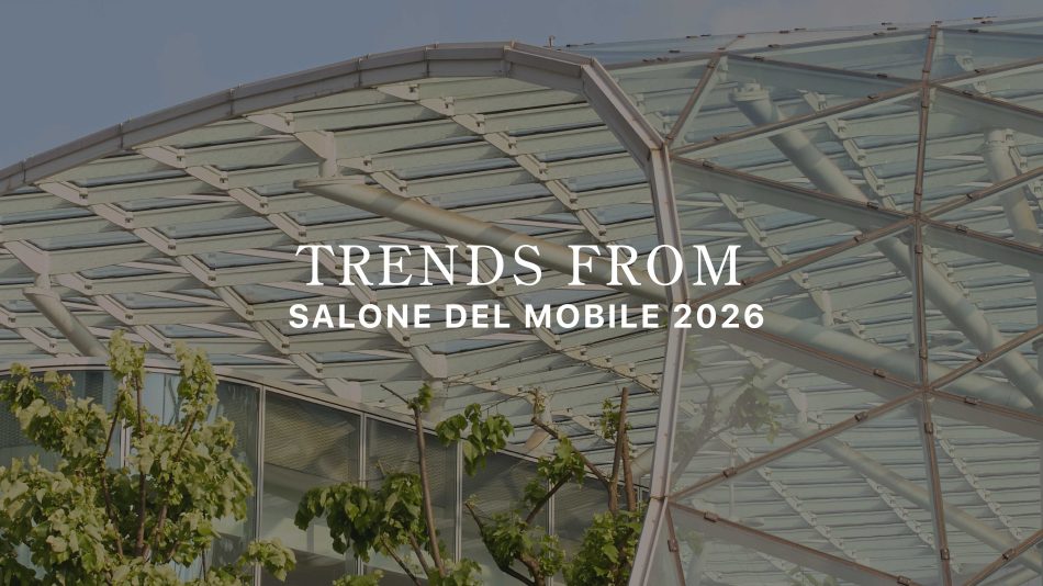 A geometric glass‑and‑steel canopy rises above lush greenery, framing the title “Trends from Salone del Mobile 2026.” The architectural transparency and natural elements echo this year’s themes,tactile materials, earthy palettes, organic forms, crafted details, and sculptural surfaces,capturing how Salone del Mobile 2026 moves beyond aesthetics toward more human, grounded, emotionally resonant design.