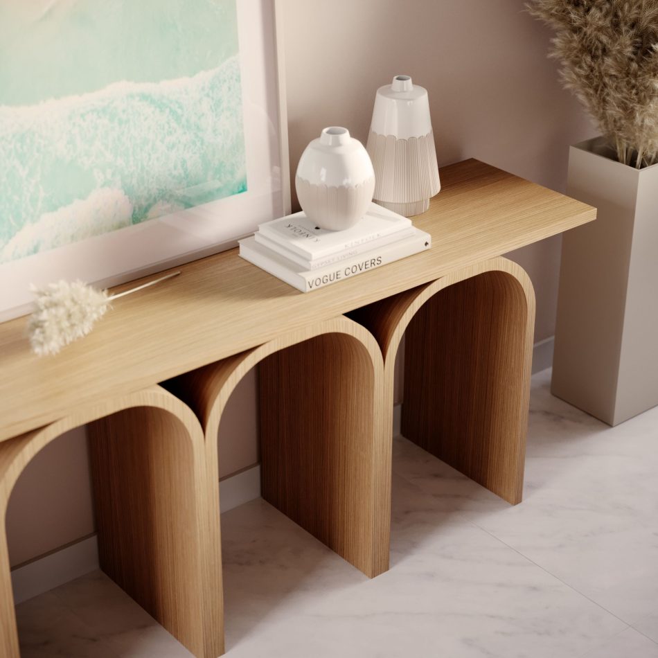 The Antónia Console is styled with ceramic vases, books and dried stems, its arched silhouette softened by warm light and natural textures. A framed ocean artwork and a tall pampas arrangement complete the calm, contemporary atmosphere, blending organic elements with architectural form. The scene embodies poetic homedecor, luxury furniture and thoughtful interior design.