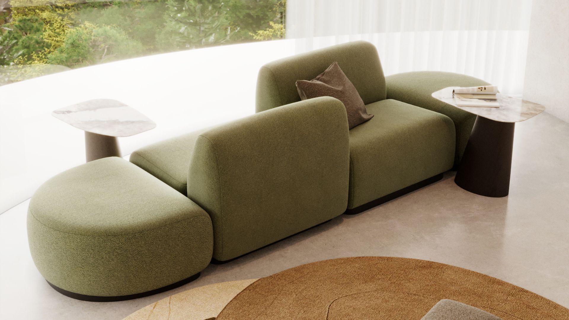 The Stone Modular Sofa, shaped with soft, rounded geometry in muted green, sits beside the Stone Side Table with its smooth marble top and sculptural base. Sunlight filters through sheer curtains, grounding the room in nature‑inspired calm and gentle curves. The scene reflects thoughtful living room design, the quiet presence of organic furniture, and a serene sense of natural interiors.