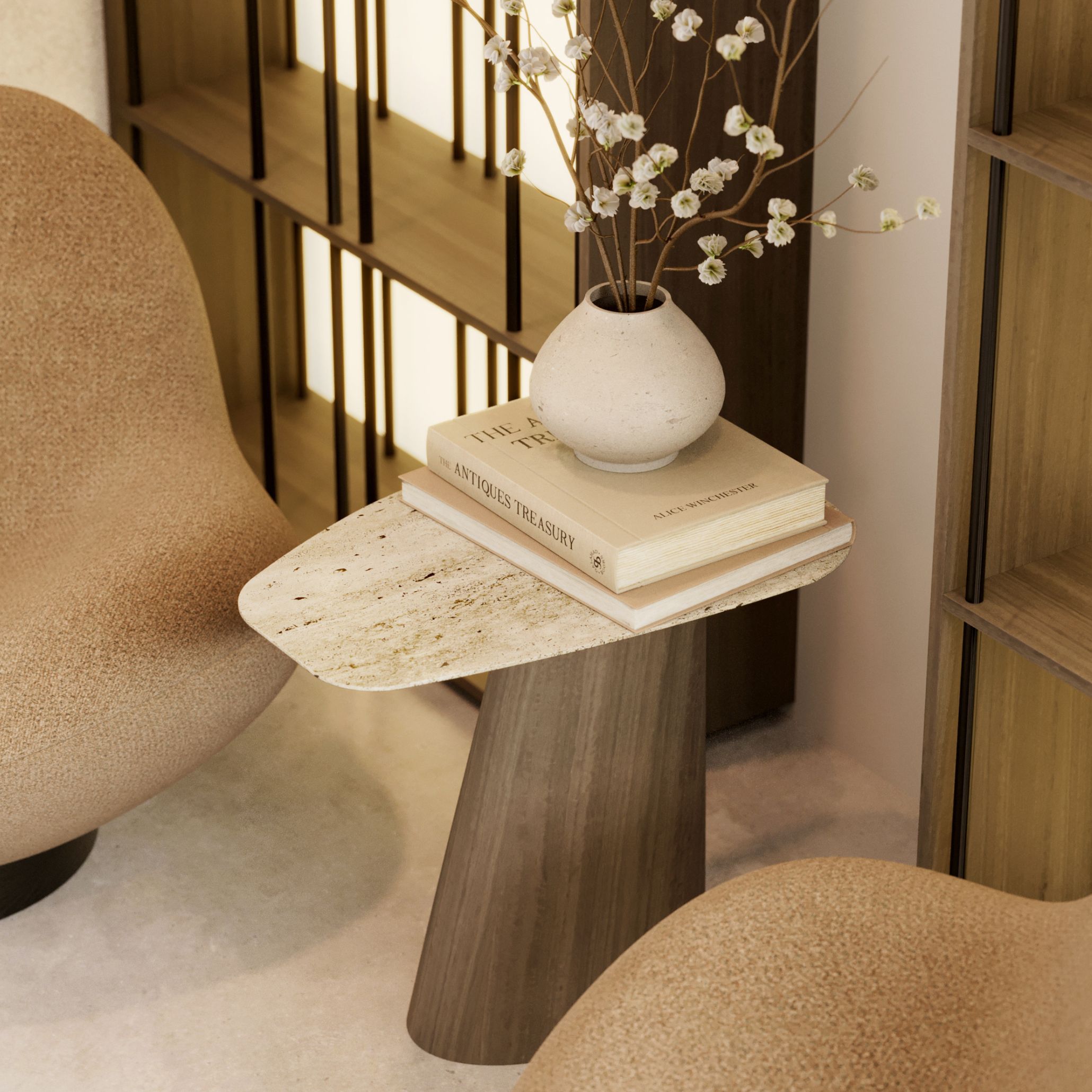 A serene reading corner centers around the Stone Side Table, its rounded marble top and sculptural base echoing the quiet variation found in natural stone. Soft seating, warm textures, and filtered daylight create a space where asymmetry and organic form feel intentional and grounding. The vignette highlights a living room design, the tactile honesty of stone furniture, and a gentle approach to nature inspired interiors.