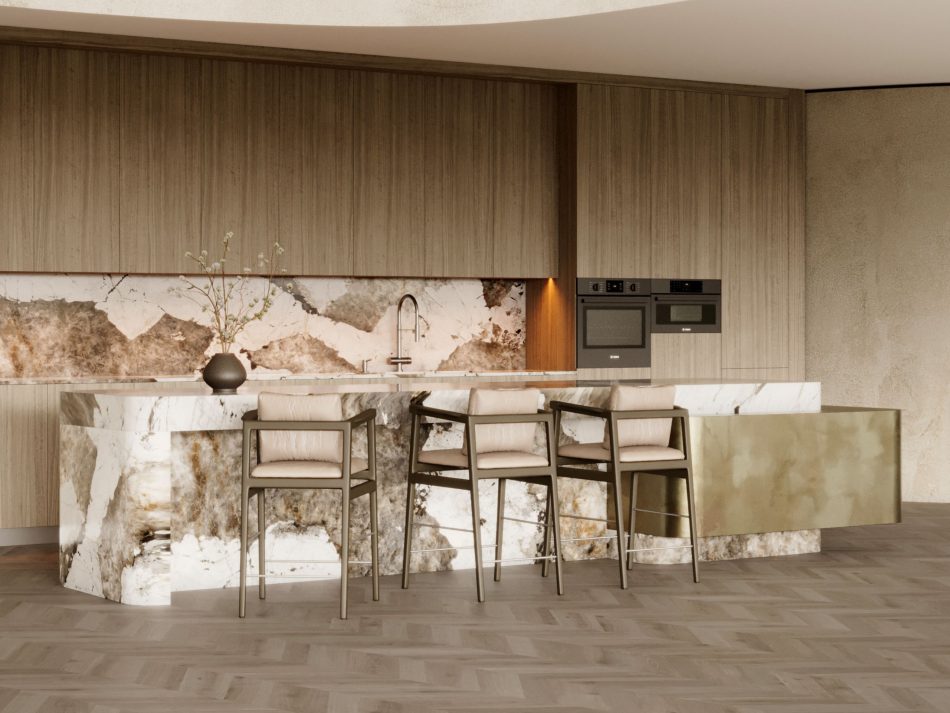The kitchen island appears carved from a single block of stone, its rounded edges and layered veining giving it a quiet, monolithic presence. Three Toro Bar Stools line its edge, their clean silhouettes echoing the room’s architectural restraint. Warm tones, crystalline textures and soft daylight shape a balanced composition rooted in modern kitchen furniture, luxury home furniture, and the calm clarity of minimalist design.
