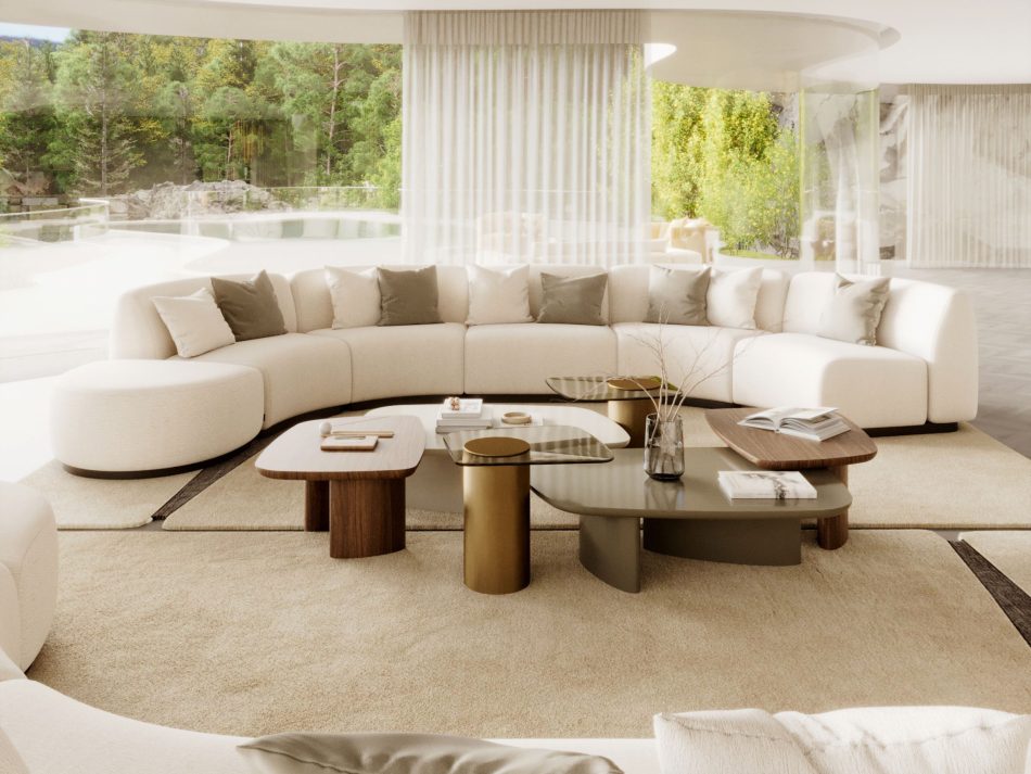 A curved Stone Sofa in soft neutral tones wraps gently around a cluster of Dolomites Coffee Tables, each surface holding books, ceramics and a delicate branch arrangement. Floor‑to‑ceiling glazing opens the room to the surrounding greenery, reinforcing the sense of continuity between interior and landscape. The composition reflects elegant living room furniture, warm luxury furniture and the sculptural restraint of minimalist design.