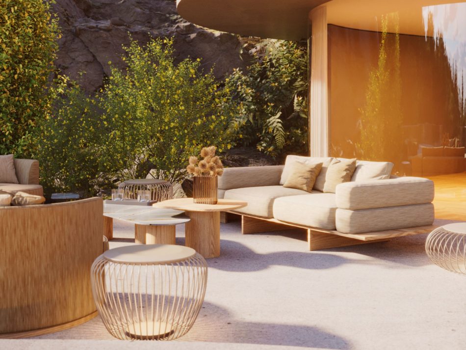 The Ripa Sofa rests on a wooden platform, its soft cushions opening toward the surrounding landscape. In front of it, the Natur Coffee Table and Natur Side Table form a low, sculptural arrangement that blends naturally with the outdoor textures. The scene reflects crafted luxury furniture, organic living room furniture and the calm balance of minimalist design.