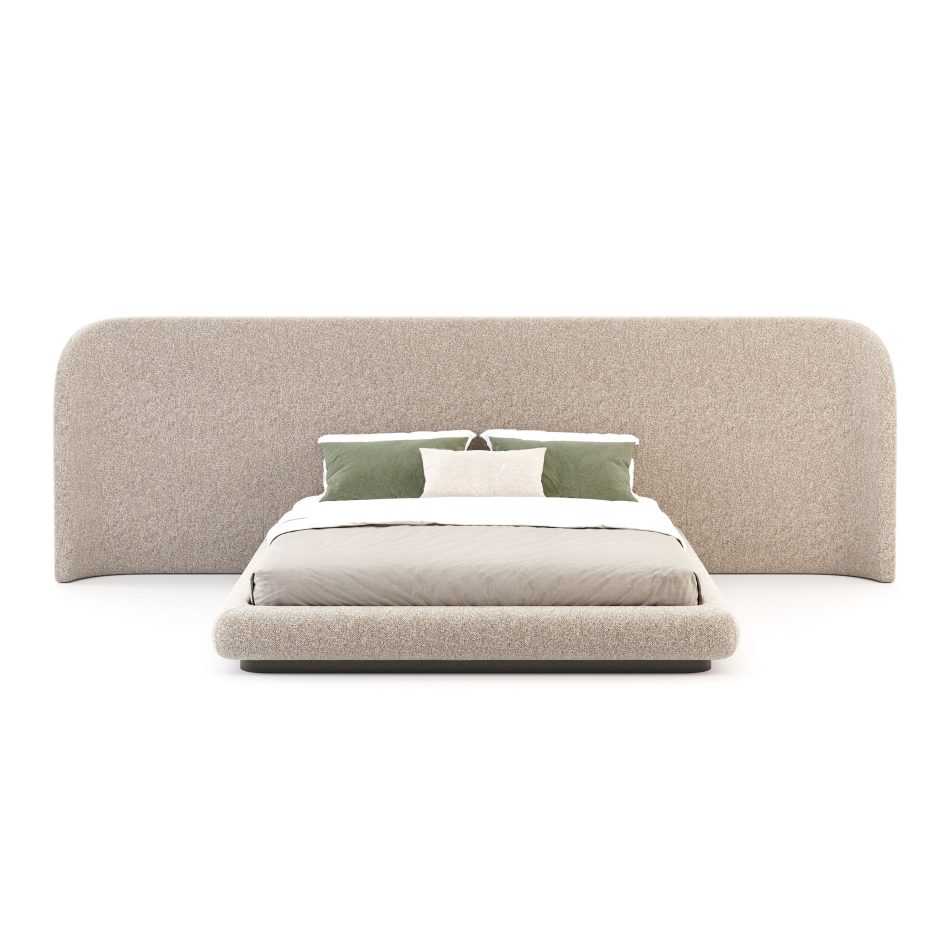 A modern Stone Bed with a wide, curved headboard and soft neutral bedding creates a serene, enveloping atmosphere. Its fluid silhouette reflects luxury bedroom furniture, while the gentle proportions introduce subtle design details that elevate the room’s interior design inspiration.