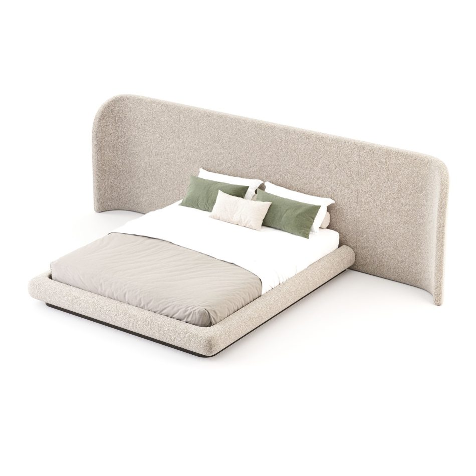 The Stone Bed features a sweeping upholstered headboard that wraps gracefully around the sides, paired with layered pillows in muted tones. The composition blends contemporary furniture with warm bedroom architecture, offering a sense of calm that enriches luxury home furniture.