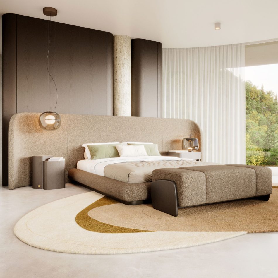 The Stone Bed anchors a serene bedroom with its curved, upholstered silhouette and warm wooden base, surrounded by soft lighting and layered textures. The space blends luxury bedroom furniture, gentle design details, and calming interior design inspiration.