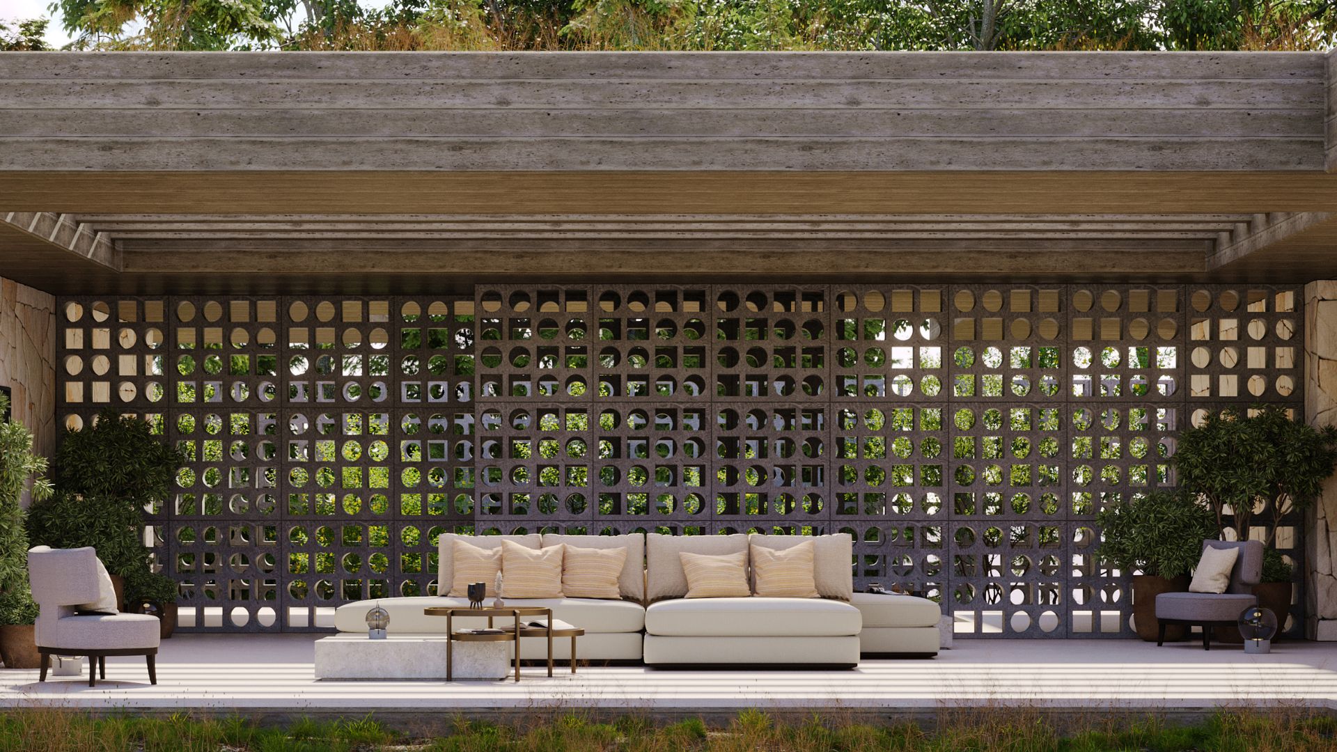 An alfresco covered outdoor lounge where living room architecture meets sculptural craftsmanship. A large decorative breeze block screen filters natural light and frames the surrounding greenery, creating a seamless visual connection between the sheltered space and the landscape beyond. A modular sofa with warm upholstery and textured cushions sits alongside luxury coffee table pieces on a ribbed concrete platform, reflecting the Italian principle that bespoke living room comfort extends naturally from indoors to out.