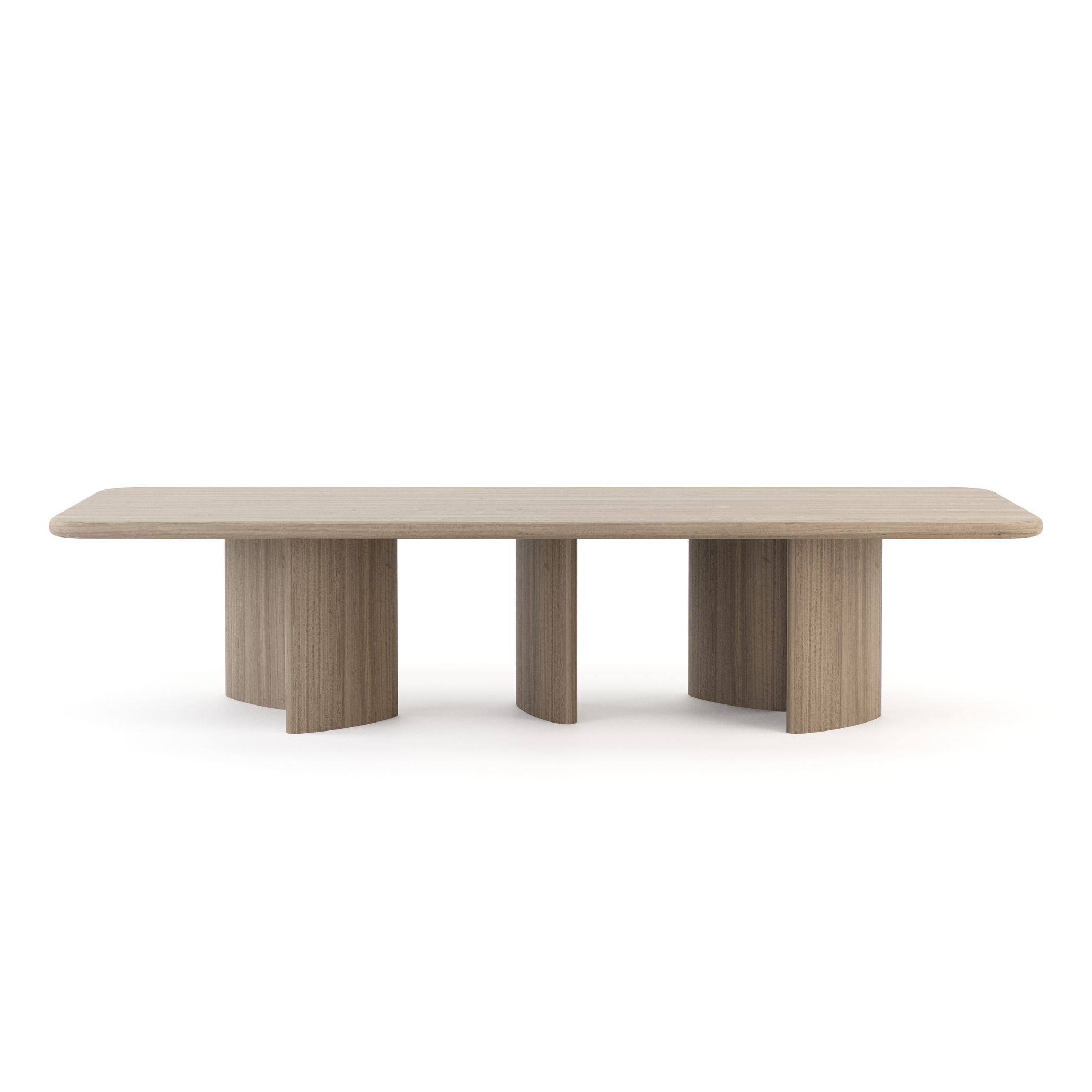 The Dolomites Dining Table in a warm natural finish, featuring a wide rounded rectangular top over three paired sculpted column pedestals with visible wood texture and grain. A modern dining table with strong architectural presence, it brings the organic character of handmade furniture into the dining room, reflecting the material honesty and minimalist design at the heart of Comporta rustic interior design.