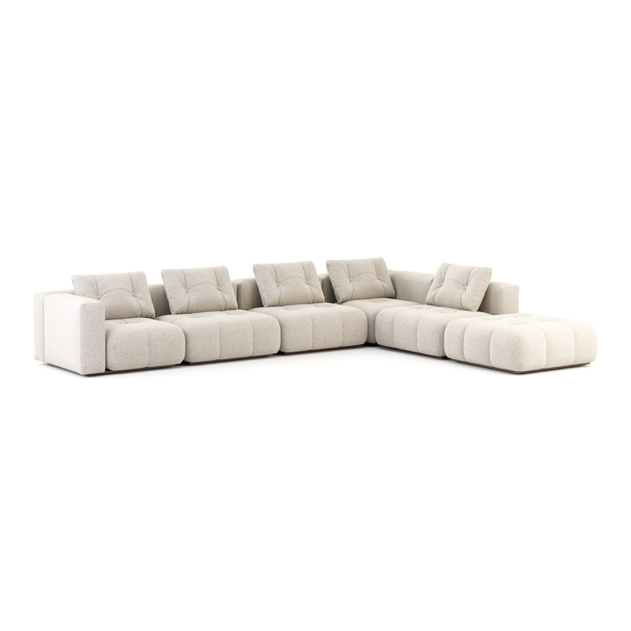 The Antónia Sofa in a generous L-shaped modular configuration, fully upholstered in cream bouclé furniture upholstery fabric with deeply tufted seat cushions and loose back pillows. A bold sofa with sculptural presence, its tactile texture and natural tones make it a defining piece for a bespoke living room inspired by the honest materials and handmade furniture craft at the heart of Comporta interior design.