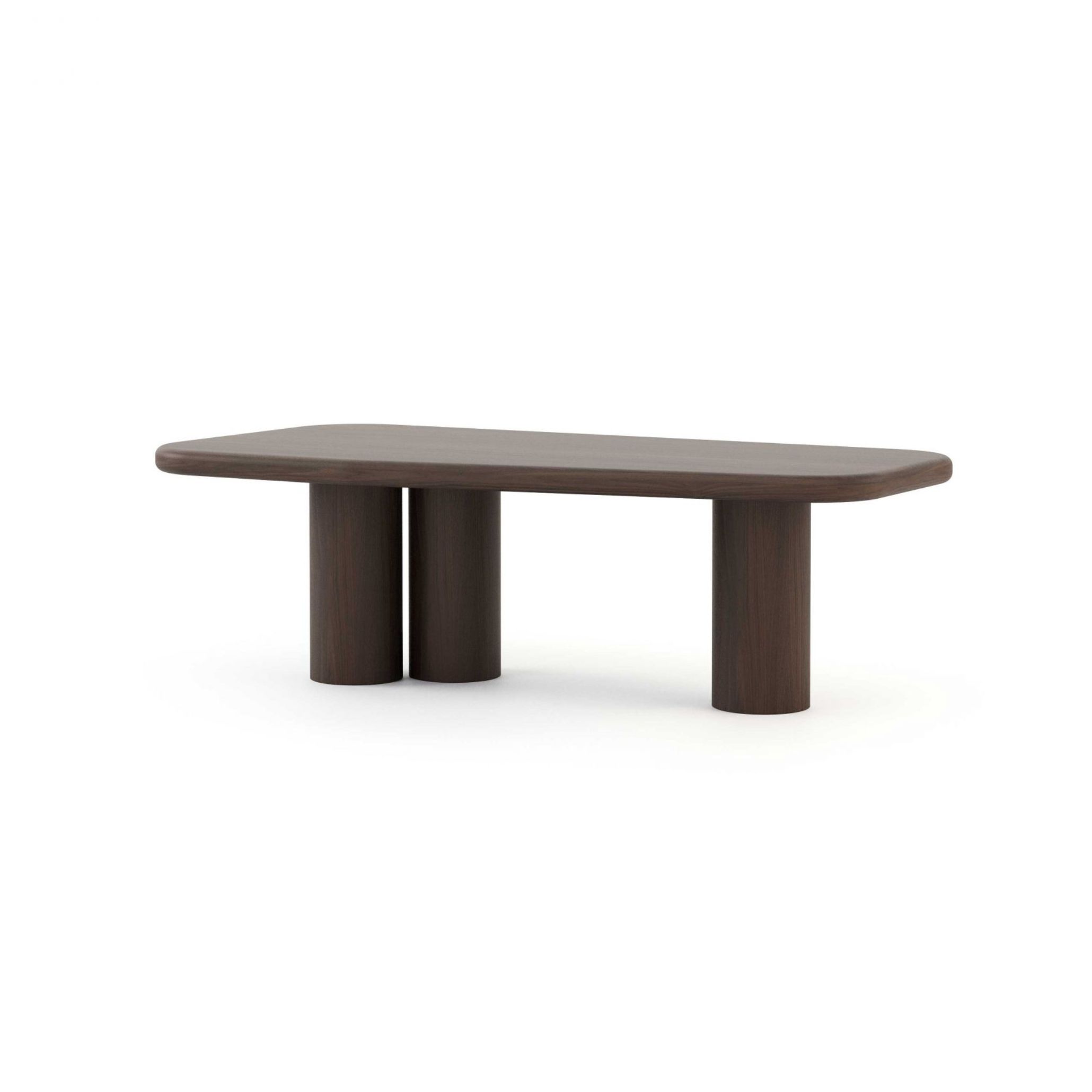 The Natur Dining Table in a dark brown finish, featuring a rounded rectangular top over three paired cylindrical column legs with visible wood texture and grain. A modern dining table with sculptural presence, its organic forms and handmade furniture quality make it equally at home in a bespoke dining room inspired by the honest material character of Comporta interiors.