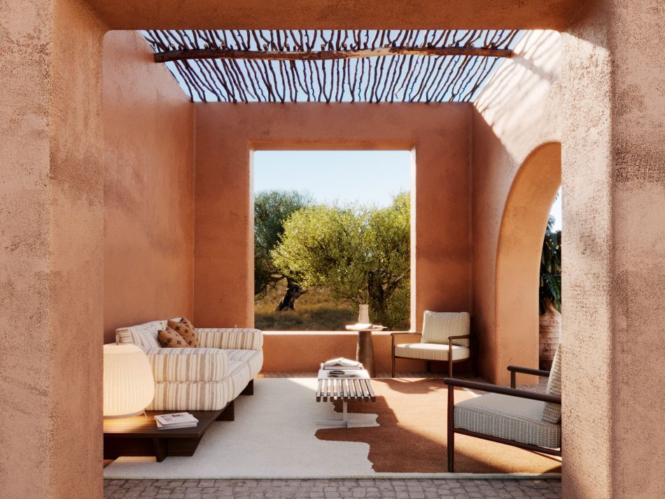 Semi-covered outdoor lounge at the Comporta Wellness Centre, framed by terracotta rendered walls and a rustic branch pergola, featuring the Ripa Sofa in striped cream furniture upholstery fabric on a dark solid wood base, a slatted wood coffee table, and the Landform Armchair in the background beside the Stone Side Table. A large square opening frames the olive grove beyond, defining a scene of hospitality designs and bespoke living room sensibility translated into an open-air Mediterranean setting.