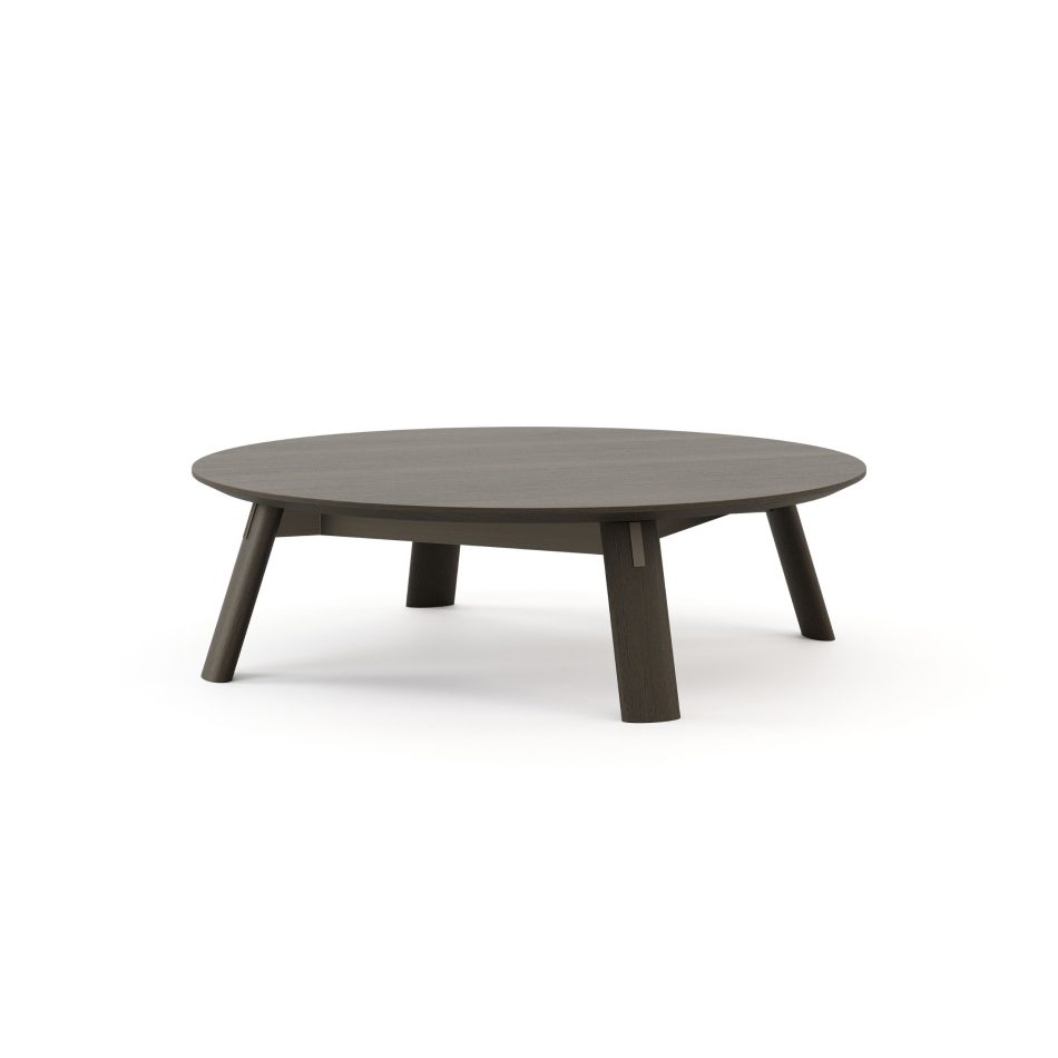 A view of the Landform Coffee Table highlights the natural grain of its dark oak top and the angled legs that give the piece its calm, mid-century presence. Subtle silver-metal joinery details mark where the legs meet the stretcher beneath. This furniture luxury design approach lets material and form speak with clarity and intention.