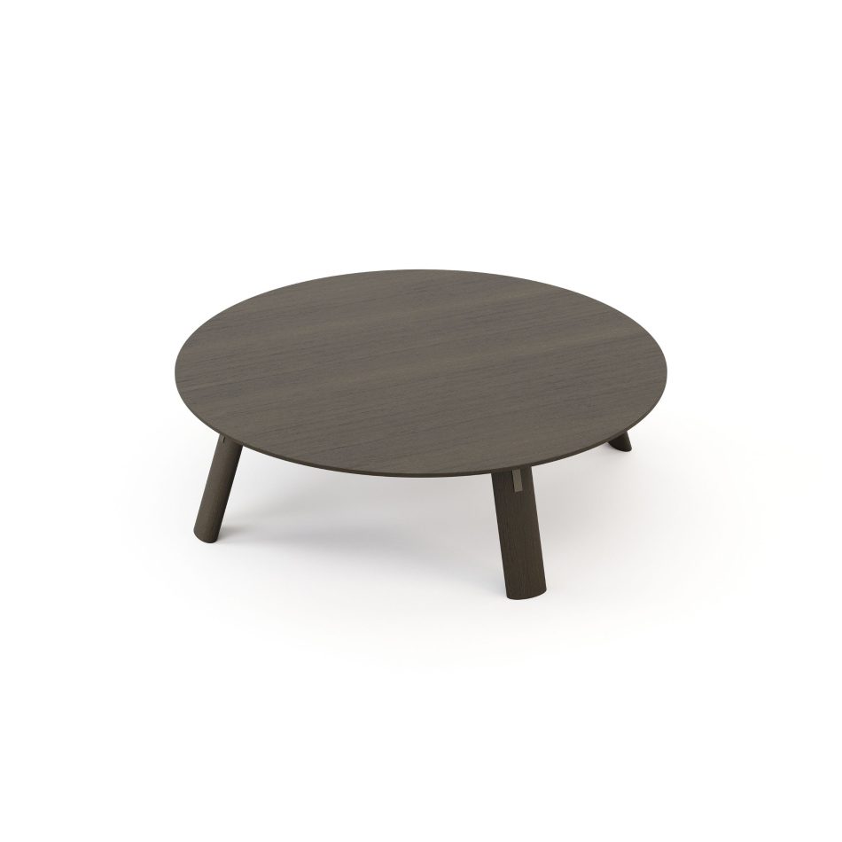 A close view of the Landform Coffee Table reveals its full round top in rich dark wood, supported by four tapered legs with a visible silver-metal inlay at the joinery. The balanced proportion and honest materiality reflect a piece of contemporary furniture designed to settle naturally into everyday life, an example of modern furniture rooted in simplicity.