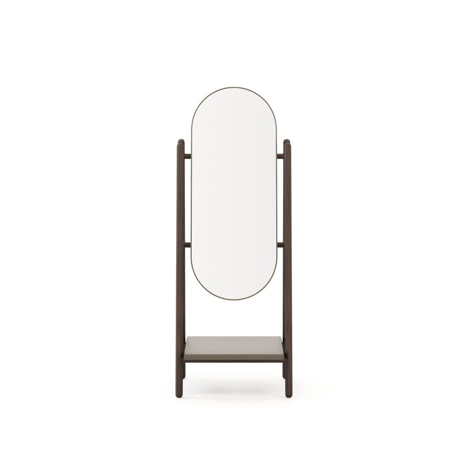 Landform Mirror front view, featuring a full-length oval mirror glass with a thin brass frame in an aged finish, held within a dark solid wood A-frame structure with a lower storage shelf. A considered piece of mirror for interior design that brings minimalist design and mid-century sensibility to bedroom and living spaces with quiet, lasting presence.