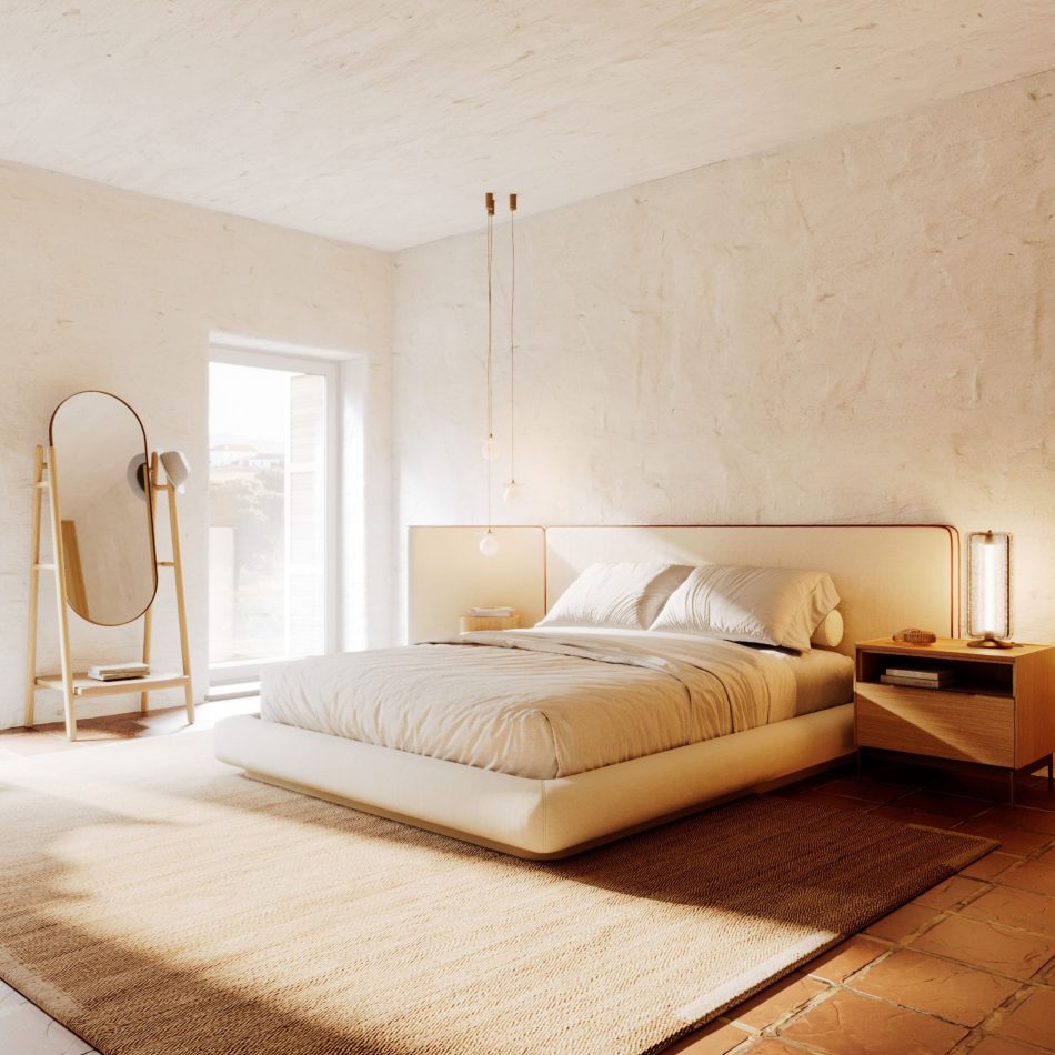 Sun-drenched bedroom with whitewashed plaster walls and terracotta floor tiles, featuring the Landform Mirror in natural solid wood with an oval brass frame standing beside the window. The Natur Bed and Landform Night Table I complete the composition in the background, creating a scene of luxury bedroom furniture and mirror for bedroom design where natural light and honest materials set the tone.