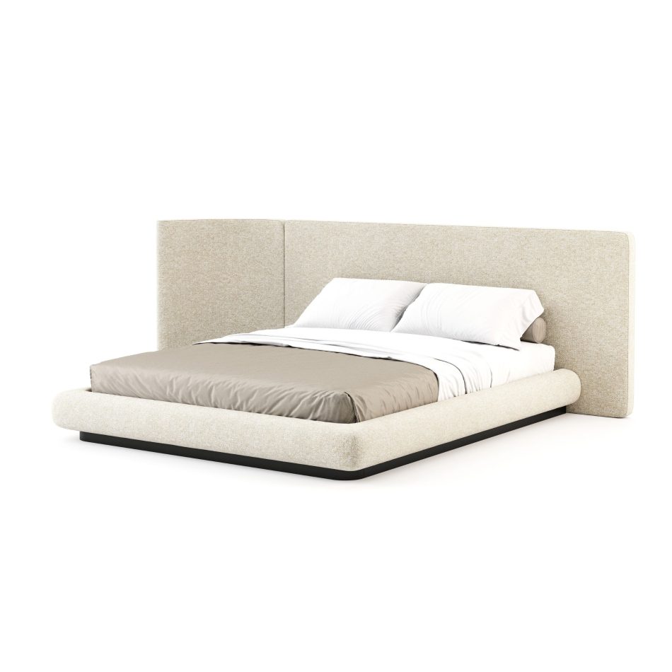 Natur Bed seen from the side, featuring a wide asymmetric headboard in natural beige furniture upholstery fabric with gently curved panel edges, a softly upholstered low-profile frame, and a dark metal plinth base. A piece of luxury bedroom furniture where organic form and considered proportion bring the calm of nature into a contemporary interior with quiet confidence.