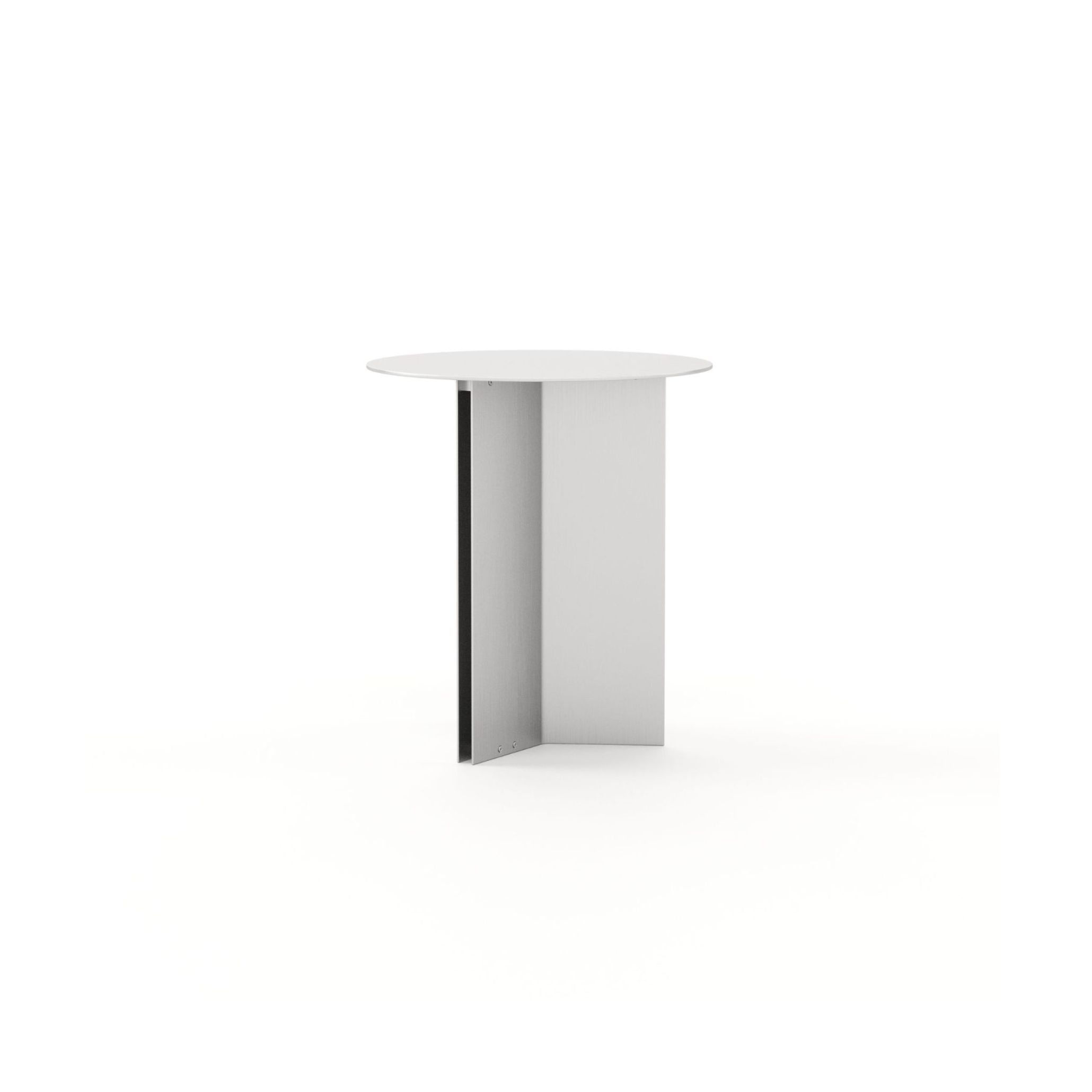 The Steel Side Table stands on a plain white background, its round white tabletop balanced on two crossed stainless steel panels with a brushed finish. The honest, precise construction reflects Van Duysen's material directness, a small object with quiet structural clarity.