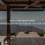 Banner image for "Rustic Greek Decor Charm: Mediterranean Interior Decor Ideas" showing a shaded outdoor dining terrace with a wooden table and woven chairs overlooking mountains and the sea, capturing luxury dining room furniture in a rustic greek setting.