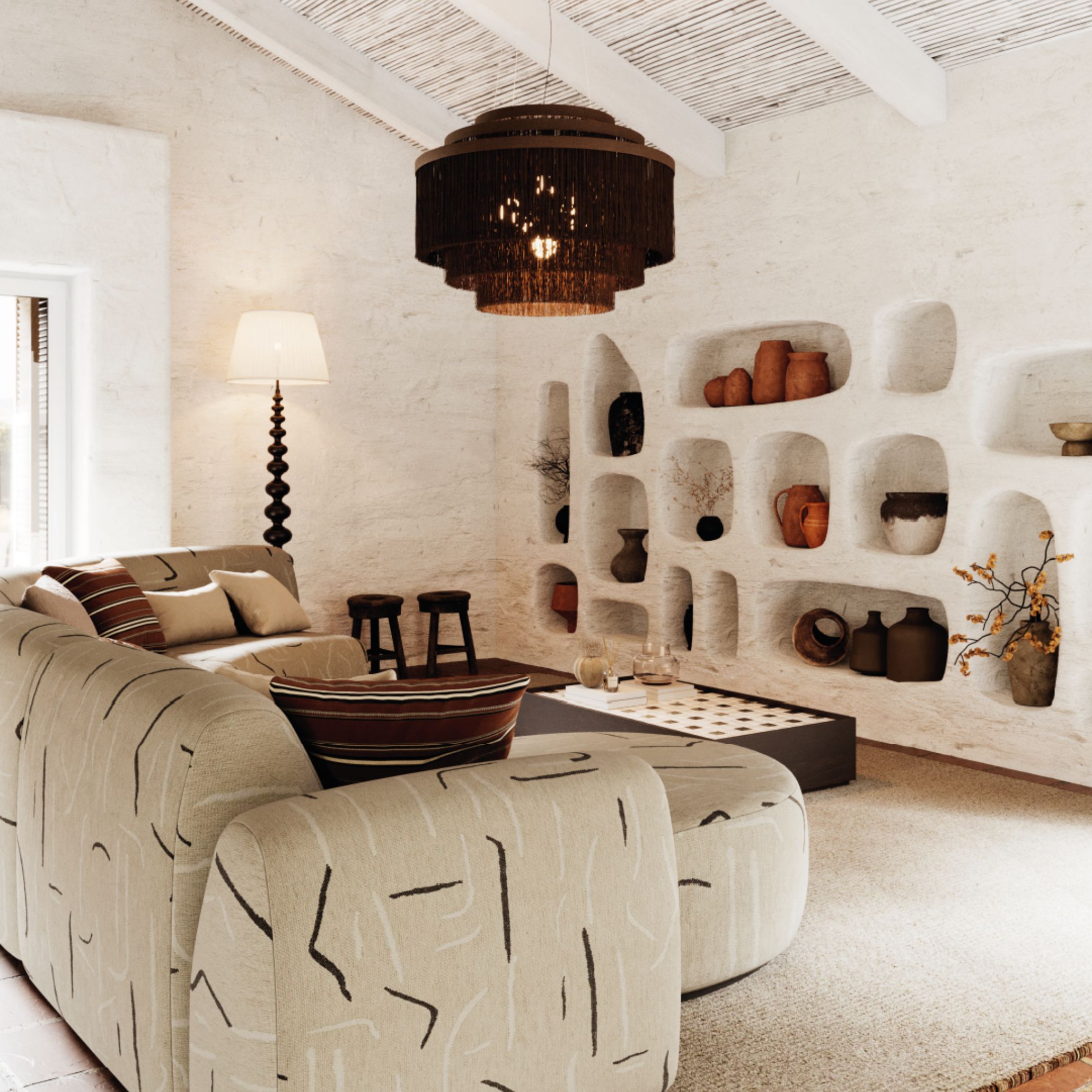 Rustic living area with textured sofas, woven pendant light and sculptural terracotta niches, reflecting wellness space design through craftsmanship, natural materials and a sense of wellbeing.
