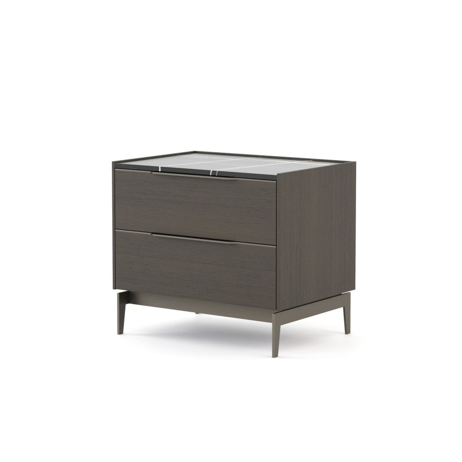 A side-angle view of the Landform Night Table II reveals the depth of its dark smoked finest wood carcass and the precise edge of the Sahara Noir marble top. Two horizontal drawers with recessed pulls sit flush within the body, supported by slender metal legs. This bedroom furniture piece carries its design details with restraint, where material honesty defines the character of the whole.