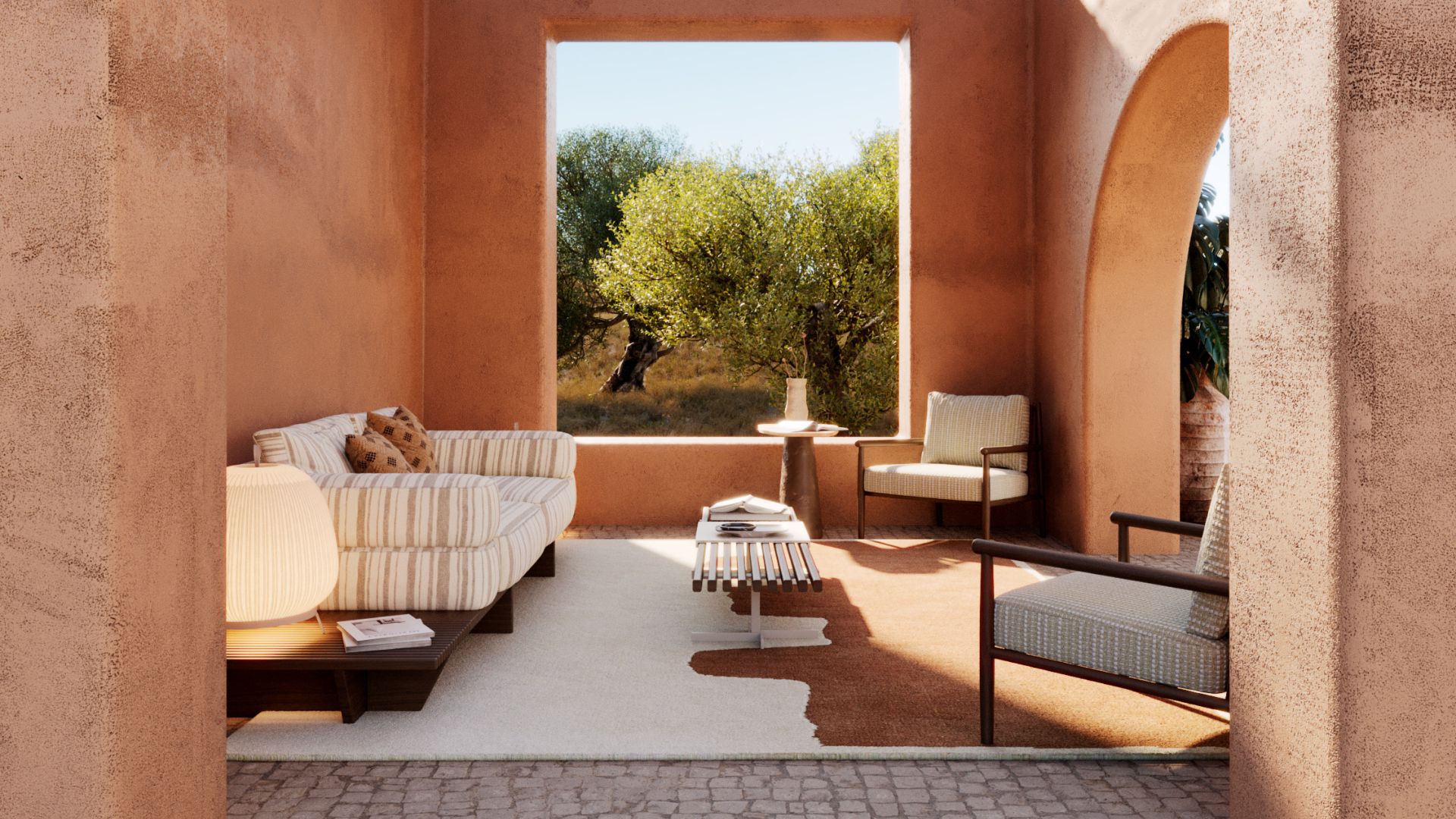 A terracotta-hued lounge framed by an arched window overlooking olive trees, featuring the striped Ripa Sofa, checked Landform Armchair and the Stone Side Table, an inviting outdoor furniture setting for aperitifs and evening conversation.