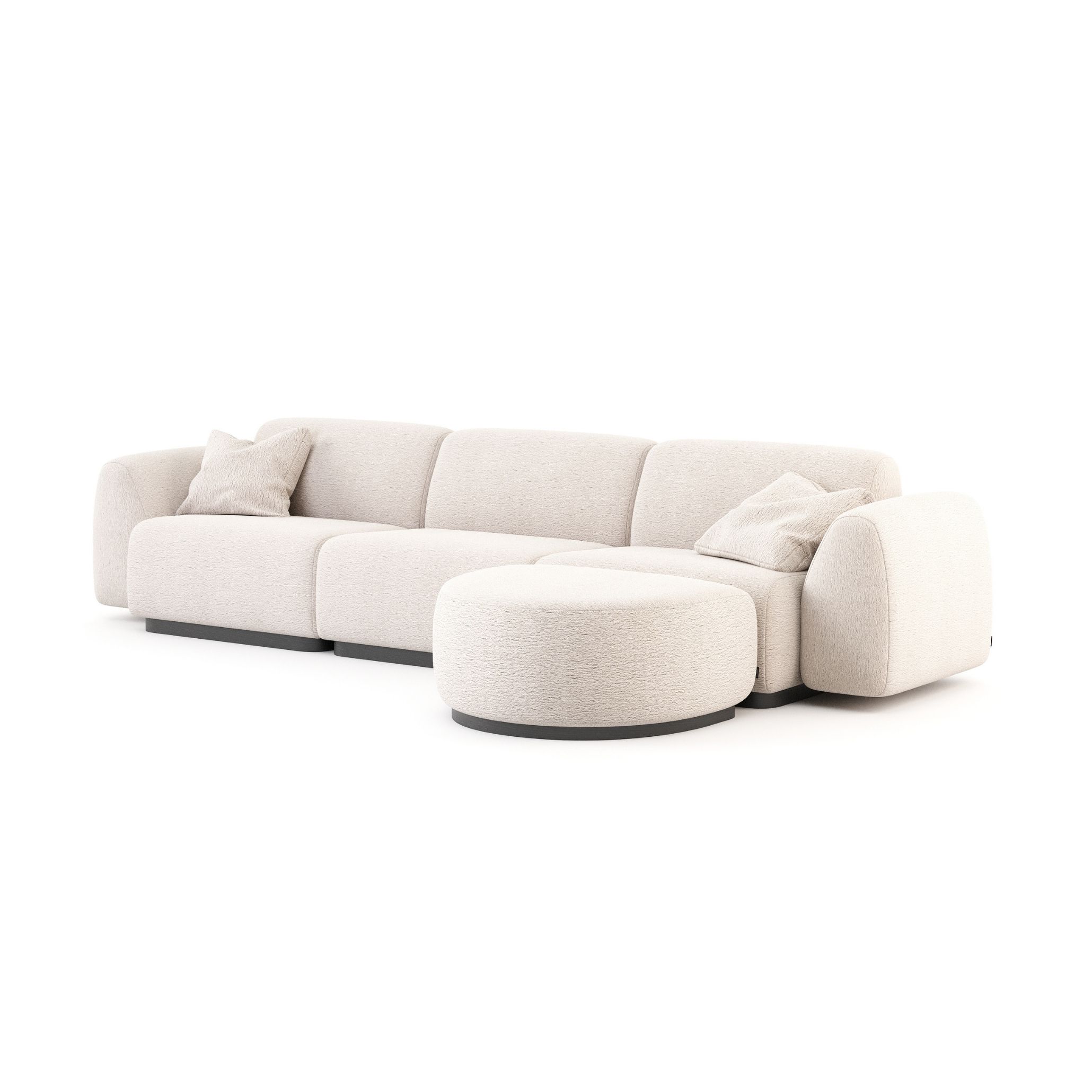The Stone Sofa shown in ivory bouclé, its sectional layout combining a rounded ottoman with generous, softly upholstered seating on a dark base. The sculptural, gracious geometry and tactile furniture upholstery reflect the restrained language of luxury living room furniture and house goals-worthy interiors, where a single well-proportioned piece of bespoke living room design can anchor an entire space.