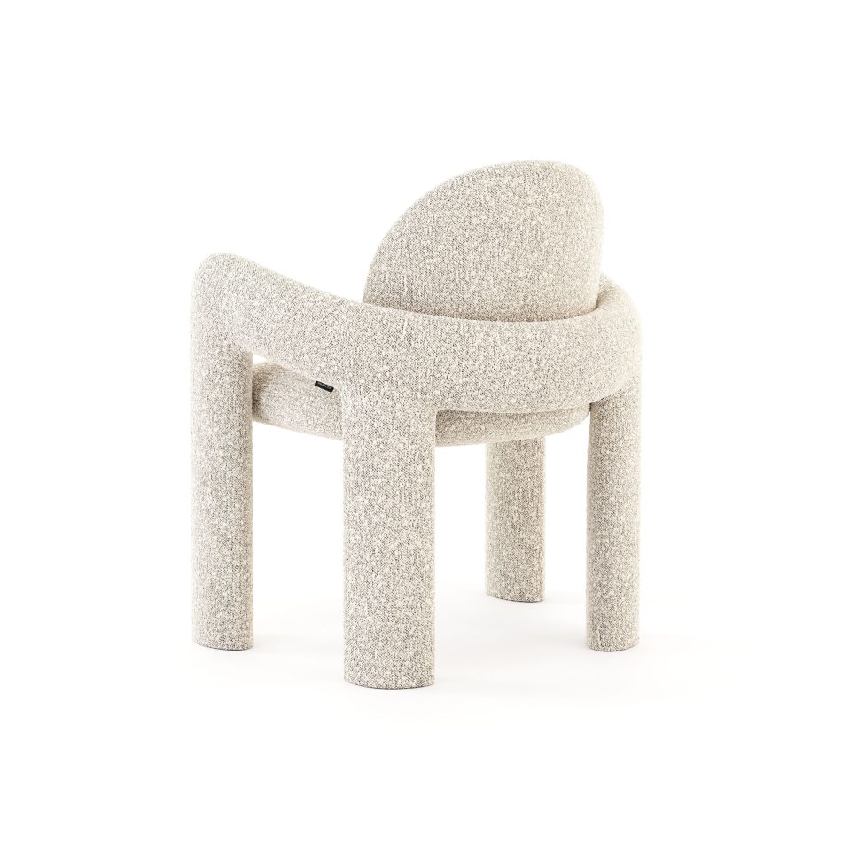 The Stone Chair, showing the back of its arched backrest wrapped in bouclé and the four sturdy legs beneath. The rounded, uninterrupted form reflects careful chair design and works well as a statement piece of living room furniture.